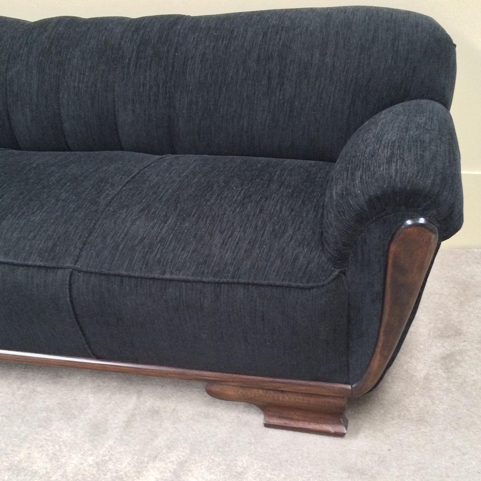 A spectacular Art Deco sofa with asymmetric design. In excellent condition being recently restored and reupholstered in Zen Ebony a textured velvet fabric. Dimensions: 196cm wide, 78cm deep, height 69cm. 

 