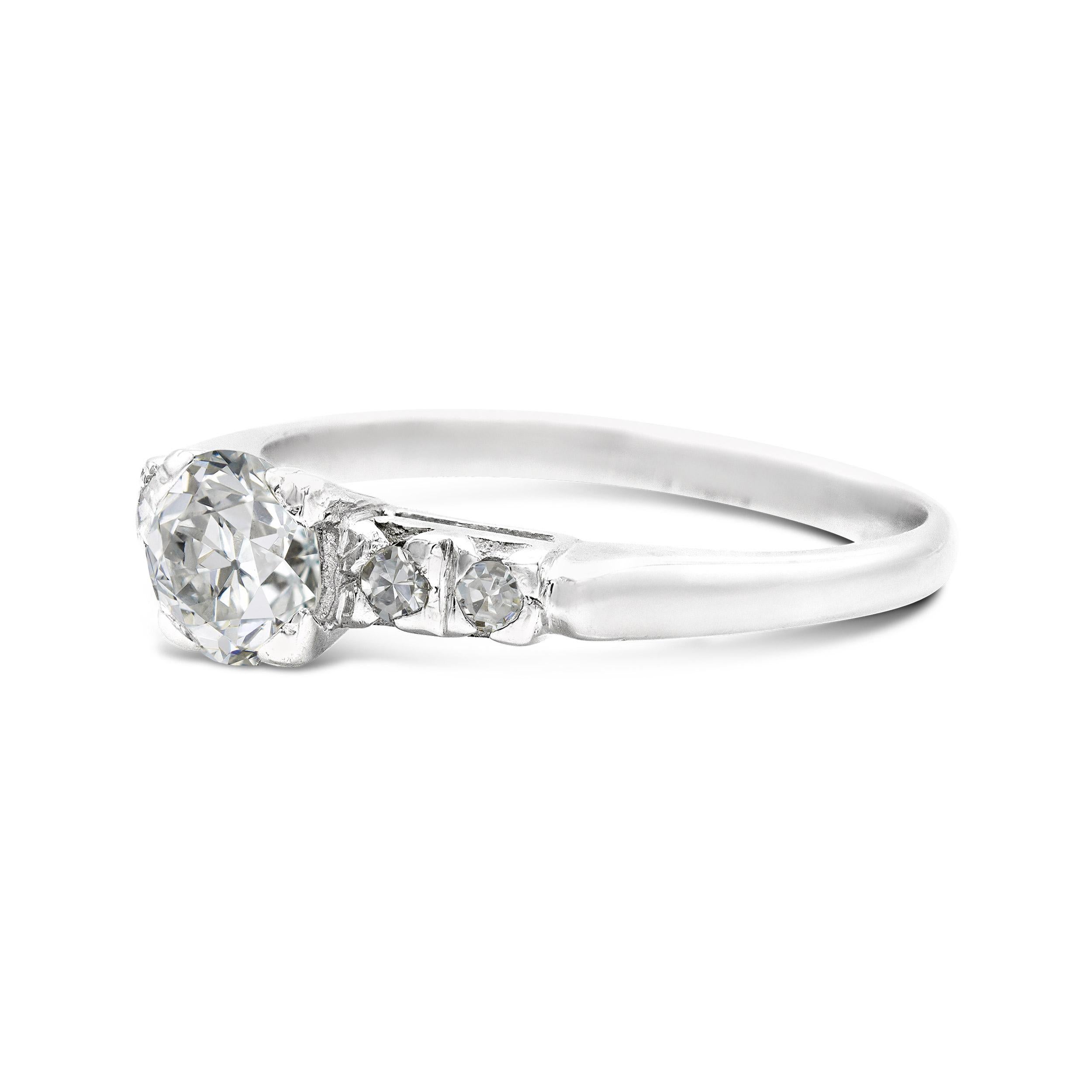 A charming Deco-era engagement ring that features all the things we love in a vintage diamond. The center diamond's visible culet and flowery facets give this classic ring style a distinctive old-world look. Single cut shoulder accents pierced in