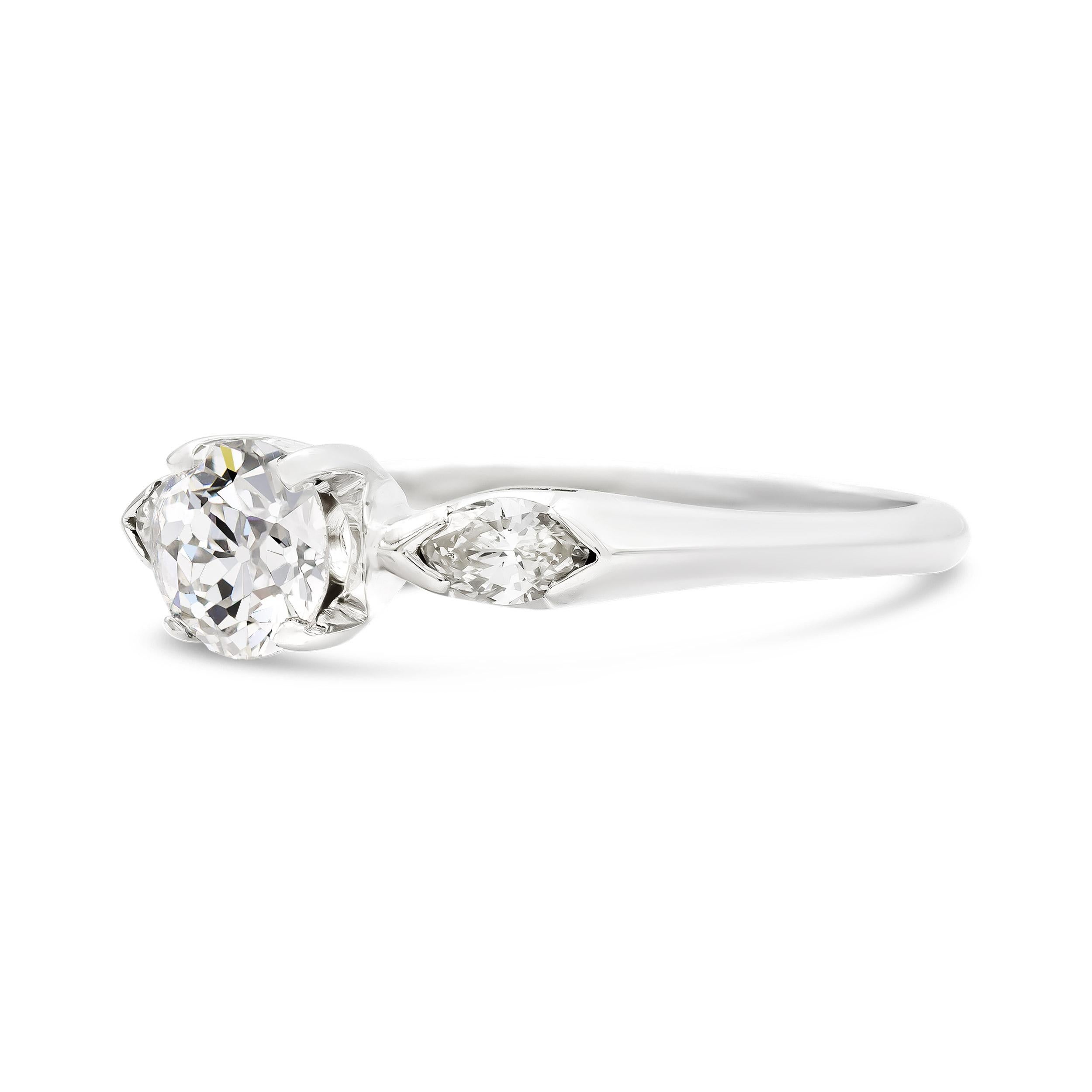 Crisp, clean, and brilliant. That's just what will come to mind when you slip on this super charming engagement ring. The two accenting marquise cut diamonds enhance our center old European cut perfectly. We think this ring is a great under 1 carat