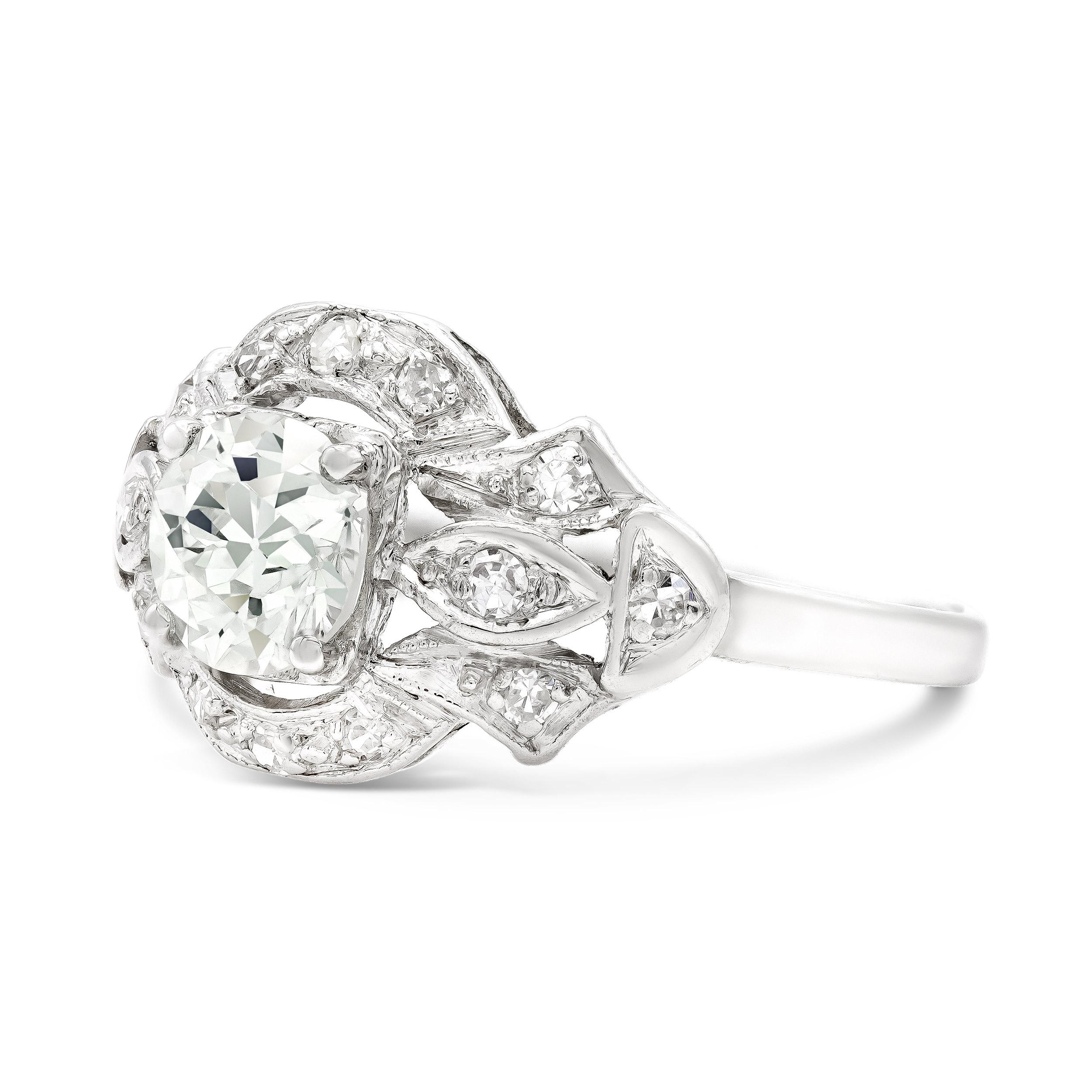 A decadently designed deco engagement ring that is both charming and bold. An irresistibly bright 0.79 carat old European cut diamond is the star of this show. We love her eye-catching facets. The diamond is wrapped up in some some single cut