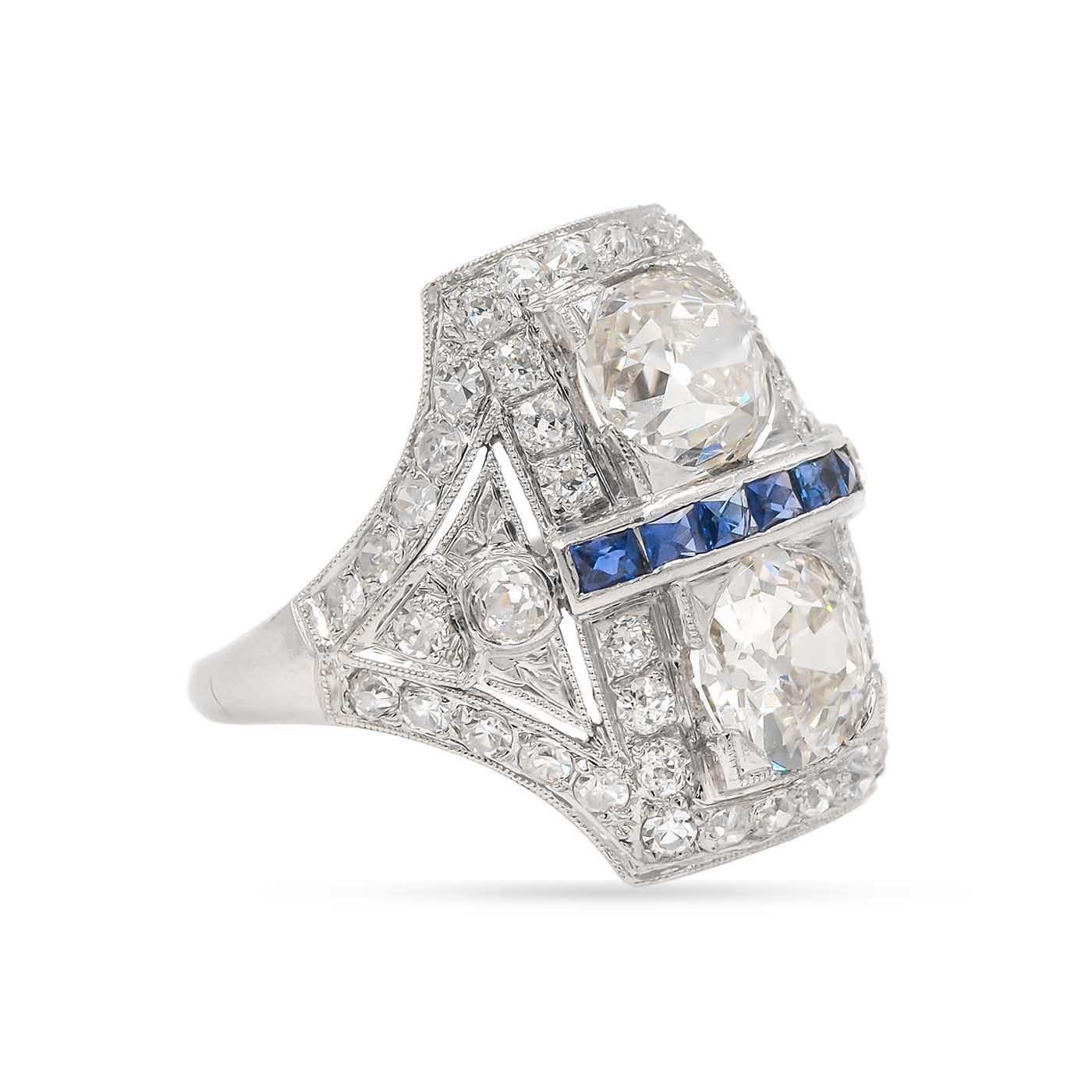 Superb Art Deco era 2-Stone Ring with two Old Mine Cut Diamonds and Sapphires, composed of platinum.  One of the Old Mine Cut diamonds weighs 1.26 carats, GIA certified K color/VS2 clarity. The other Old Mine Cut diamond weighing approximately 1.01