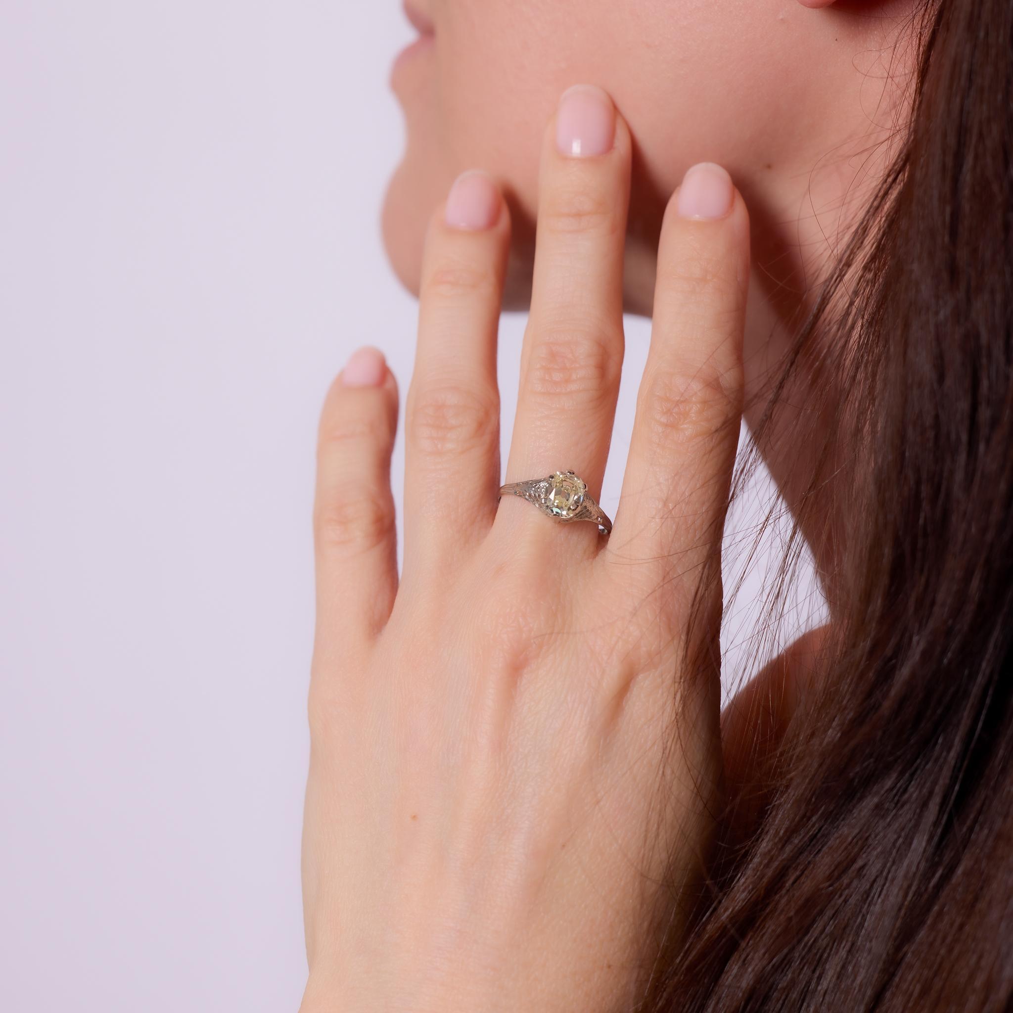 Crafted in the 1930s, this Art Deco engagement ring is set in 18k white gold and features a GIA-certified 1.39-carat old mine cut diamond, graded Q-R color and VS2 clarity. The diamond’s antique faceting and soft glow are beautifully showcased in a