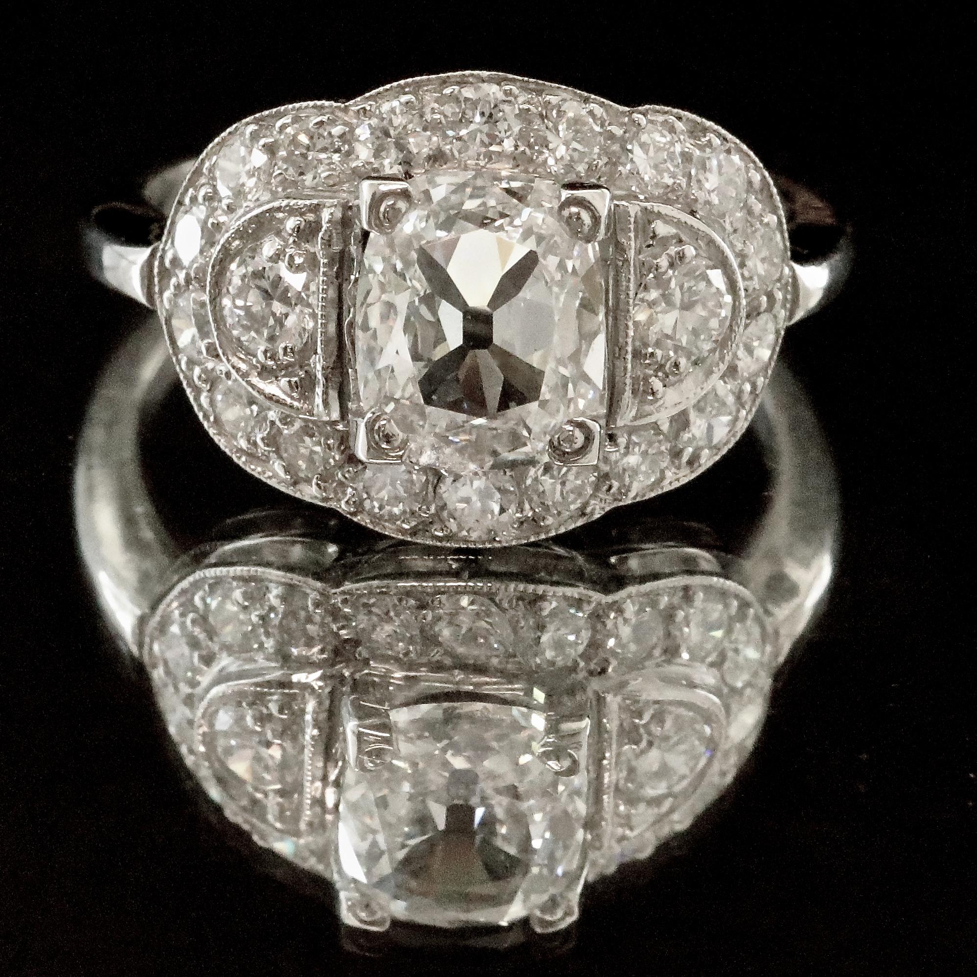 A classic Late Art Deco diamond cluster ring from the 1930's. The ring is graceful and the smooth, thin band makes it a perfect everyday accessory. Enjoy the freshness of this beauty from long ago. GIA graded cushion cut diamond 1.52 carat, F color