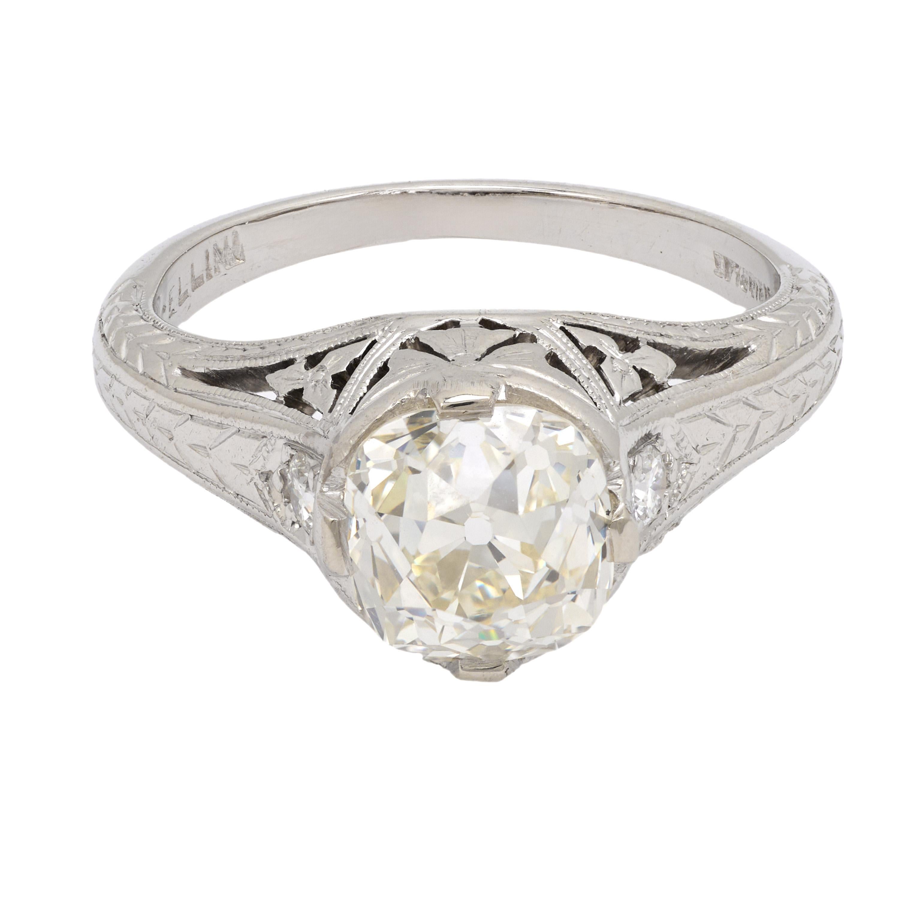 This Art Deco platinum ring features a luminous 1.65 carat GIA-certified old European cut diamond with exceptional VVS2 clarity, framed by two bright E-F color accent stones. Crafted in the 1930s, its refined geometry and rich historical character