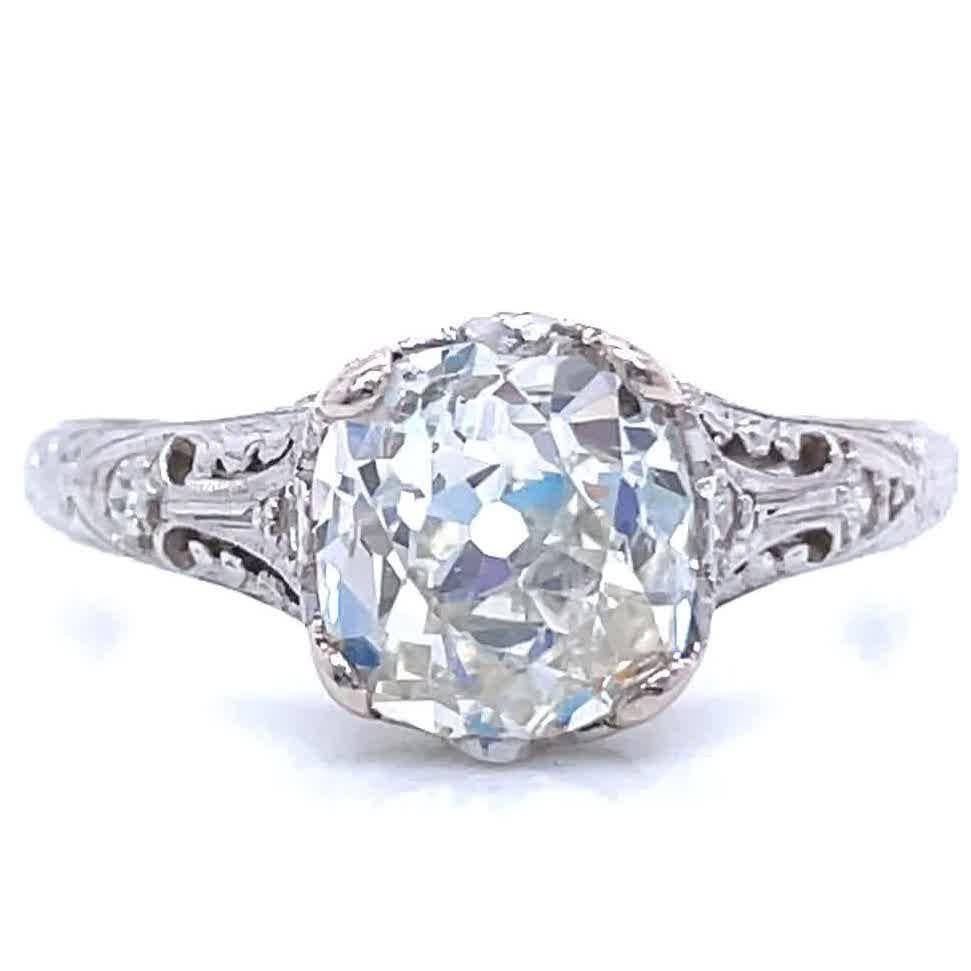 You will enjoy this intricate engagement ring with lots of antique charm and details. The ring is delicate with fine filigree workmanship in the best Art Deco tradition. The diamond is GIA certified as Old Mine Cut 1.81 carat, L color, SI1 clarity