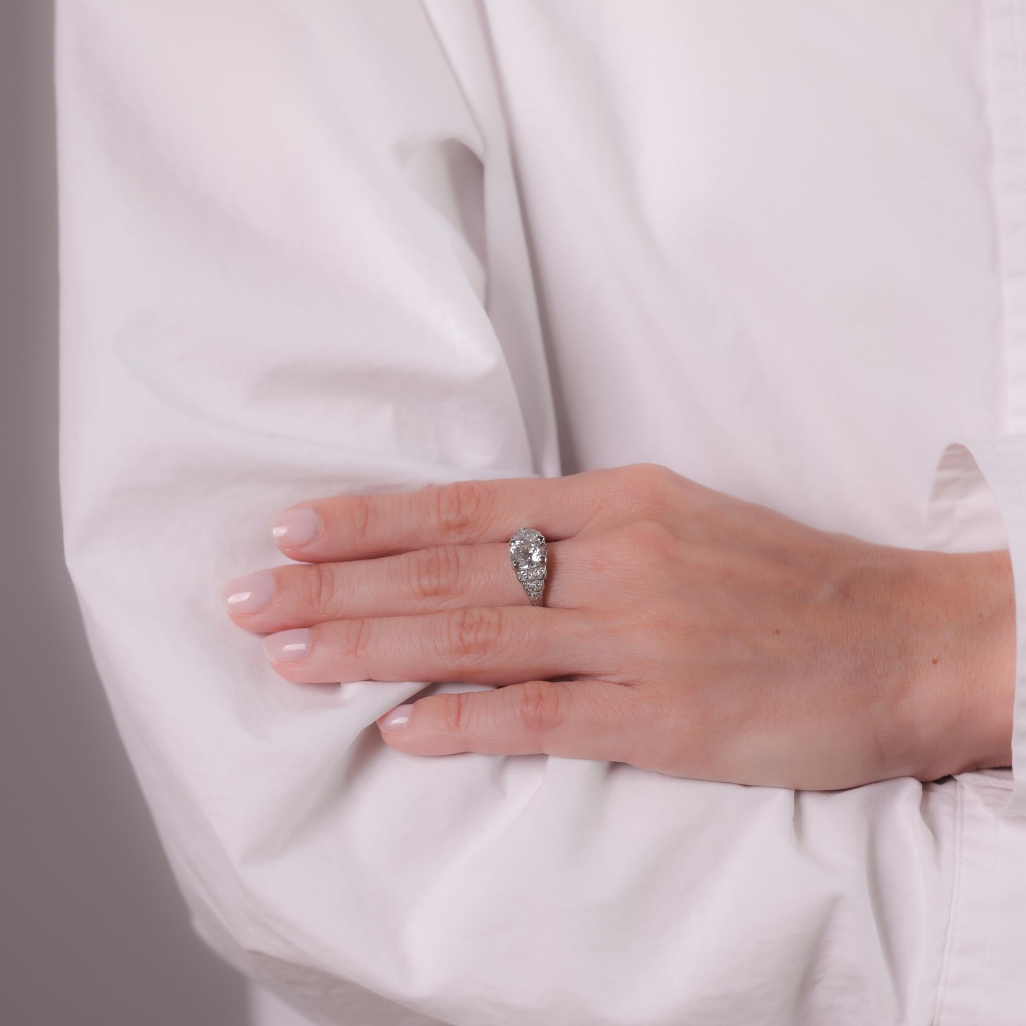 This Art Deco ring features a GIA-certified 2.15-carat Old European cut diamond, I color, VS1 clarity, accented by 12 Old European cut diamonds totaling approximately 0.25 carats, E color, VS clarity. Crafted with a platinum top and 14k white gold