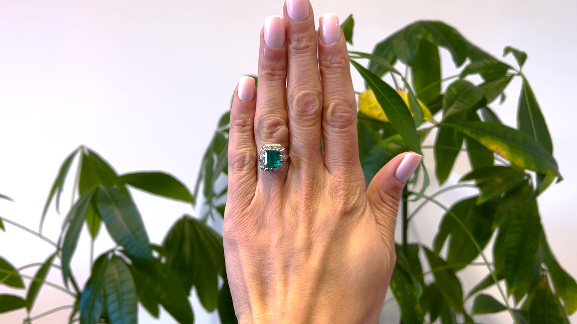 One Art Deco GIA 2.27 Carat Colombian Emerald and Diamond 18k White Gold Halo Ring.  Featuring one octagonal step cut emerald of 2.27 carats, accompanied with GIA #6234089150 stating the emerald is of Colombian origin. Accented by 18 single cut