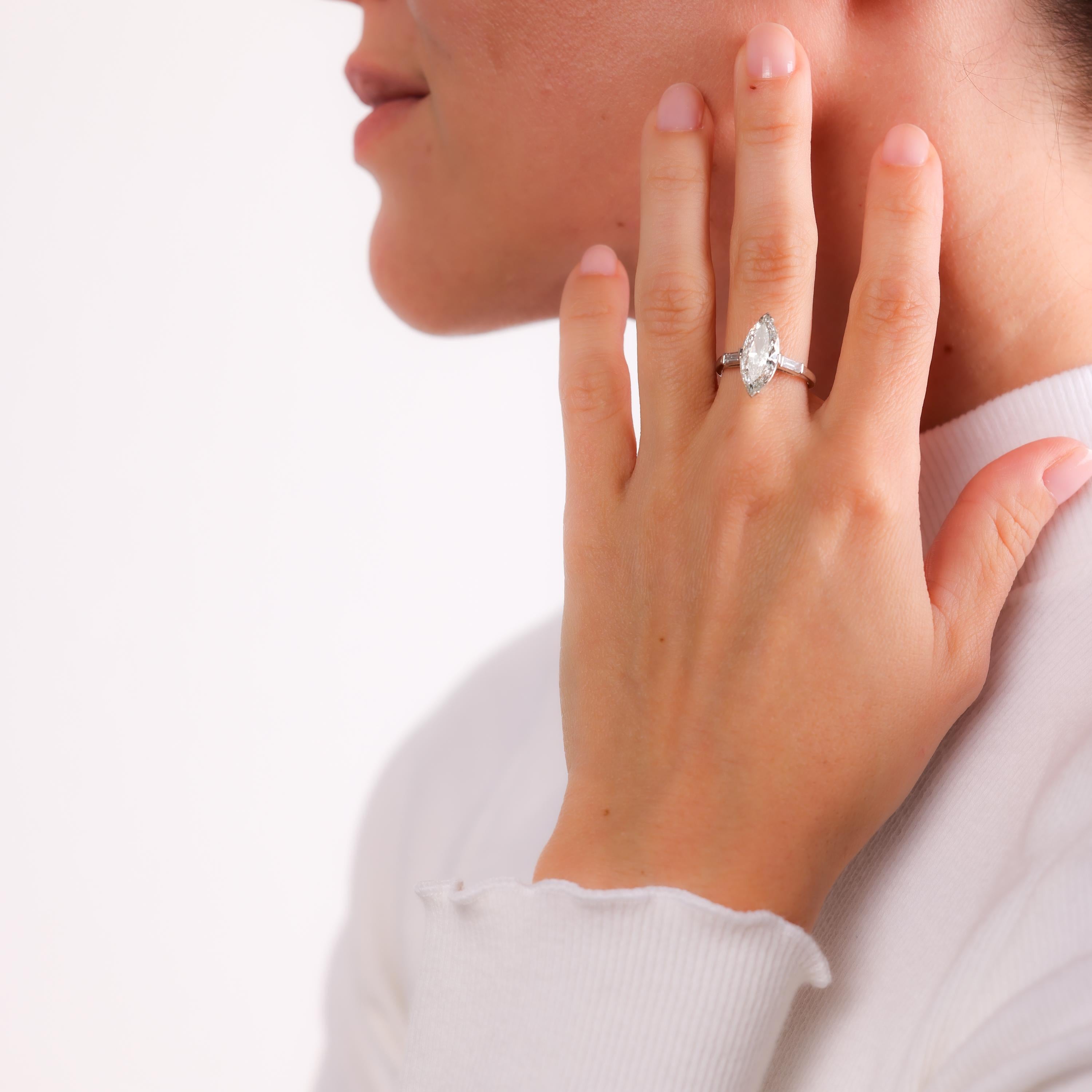 This exquisite Art Deco engagement ring showcases a 3.01-carat GIA-certified marquise-cut diamond, flanked by baguette diamonds in an elegant platinum setting. Timeless sophistication.

Certificate: GIA #17169935
Center stone: Marquise cut diamond