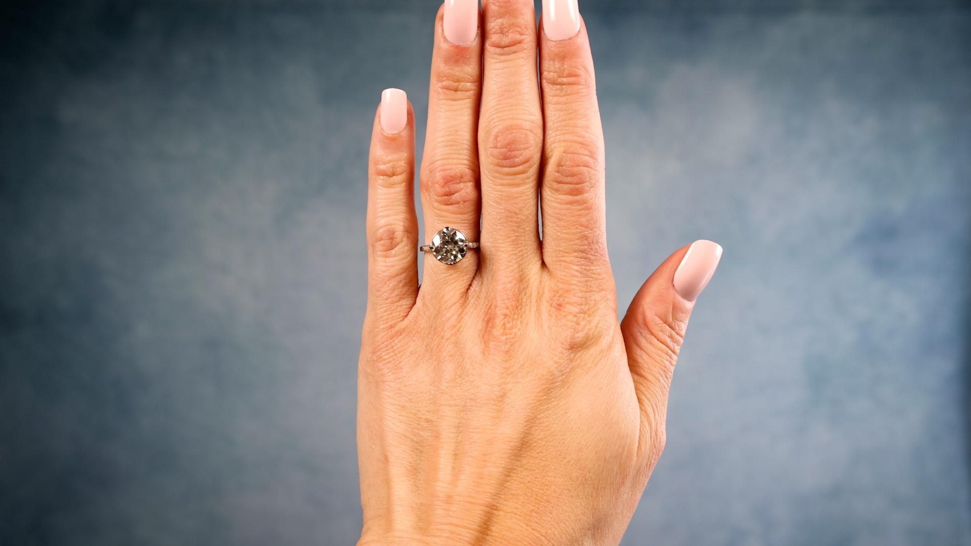 One Art Deco GIA 3.42 Carat Old European Cut Diamond Platinum Ring. Featuring one GIA old European cut diamond of 3.42 carats, accompanied with GIA #1236159291 stating the diamond is M color, SI2 clarity. Accented by eight senaille cut diamonds with