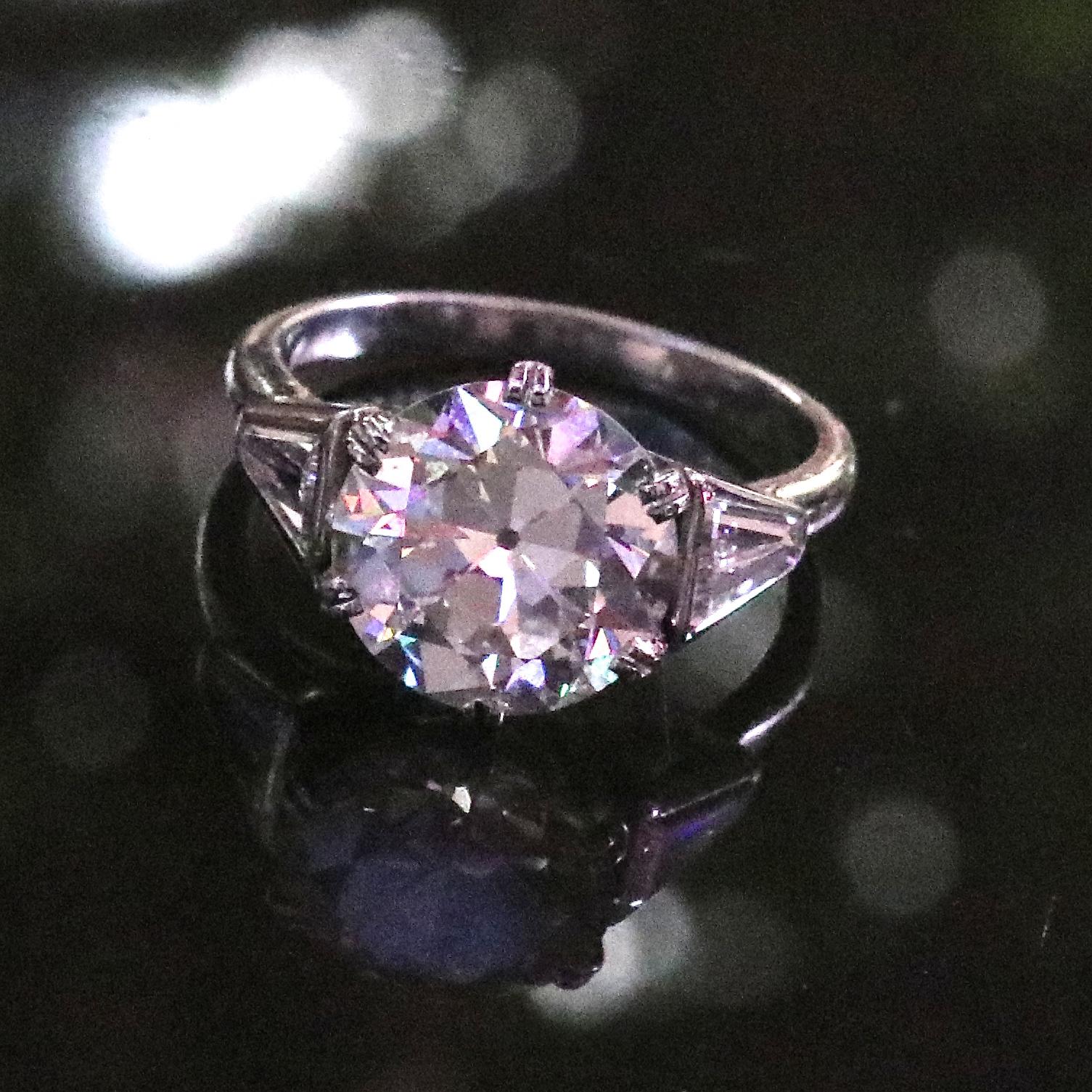 Three exquisite old cuts in one fabulous engagement ring. This original Art Deco diamond platinum ring features a GIA 3.52 old European cut diamond, graded I color, VS1 clarity.  Accompanied by 2 old trillion cut diamonds that weigh approximately