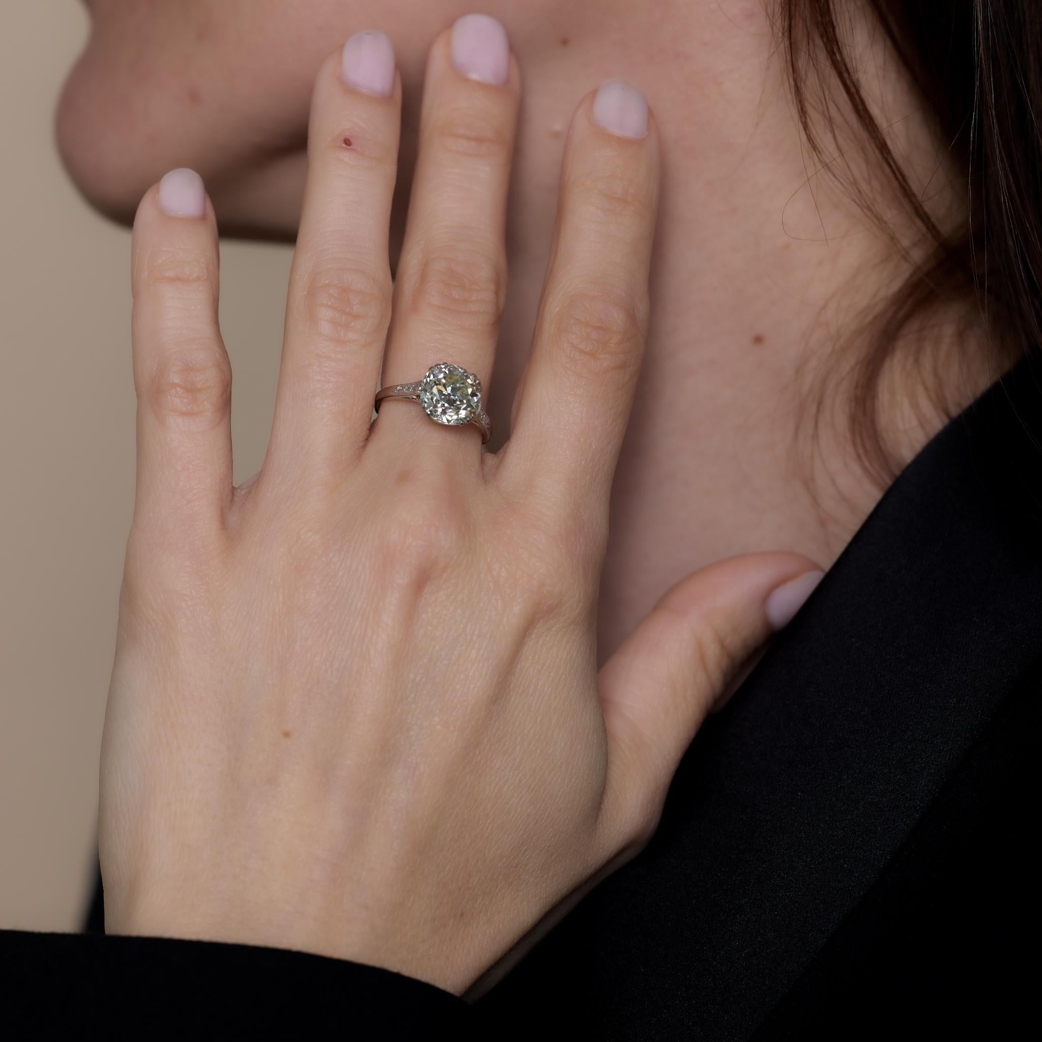 This Art Deco platinum engagement ring showcases a GIA-certified 3.60-carat old European cut diamond (O-P color, VS2 clarity), accented by six single cut diamonds totaling .06 carats, H color, and VS clarity. Crafted in the 1930s, it weighs 3.91