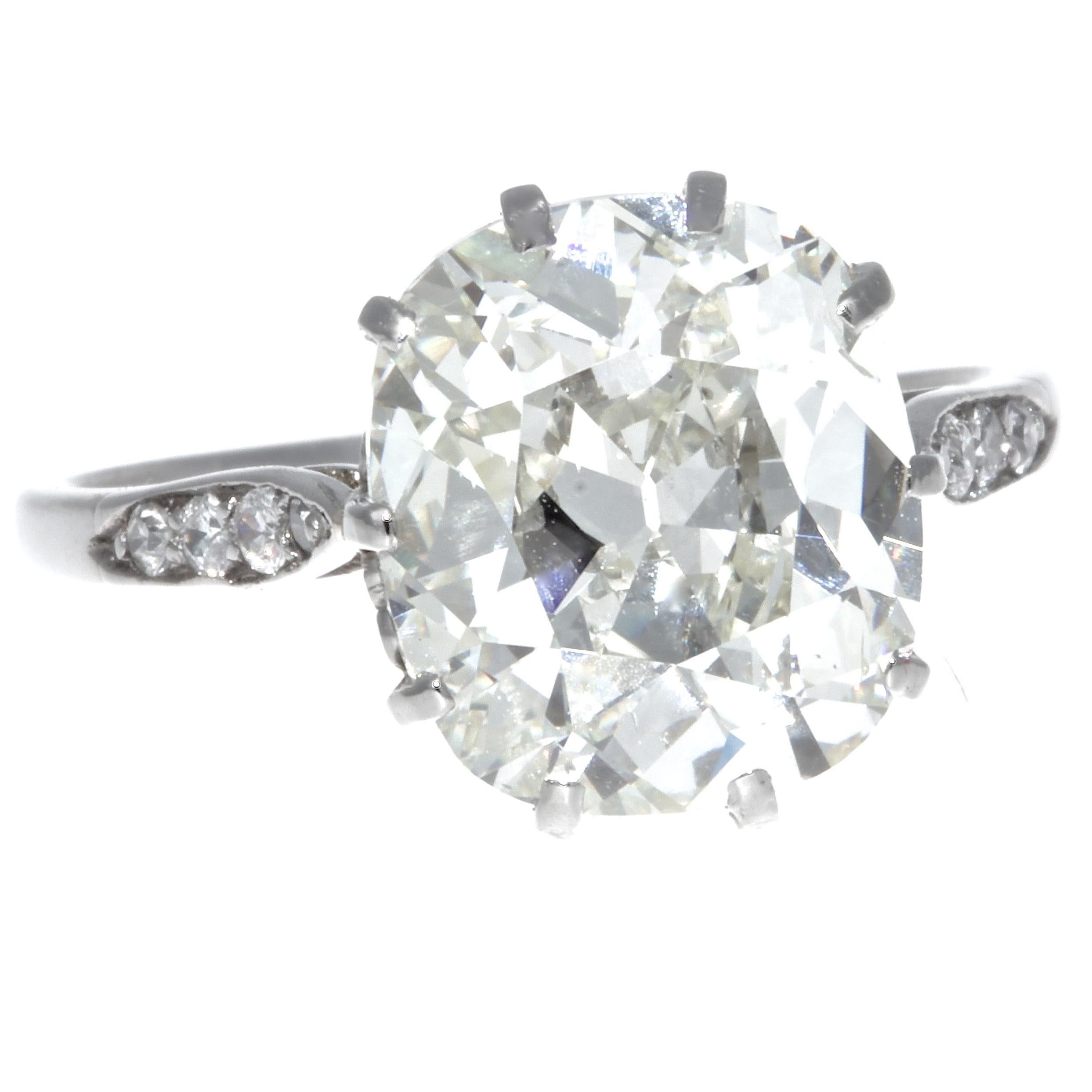 Everyone is on the hunt for these diamonds. Large carat antique cushion cut diamonds are extremely hard to find these days! We found one of the the most beautiful; a GIA certified 5.02 carat, K color, SI1 clarity. (#6214181861). Accented by eight