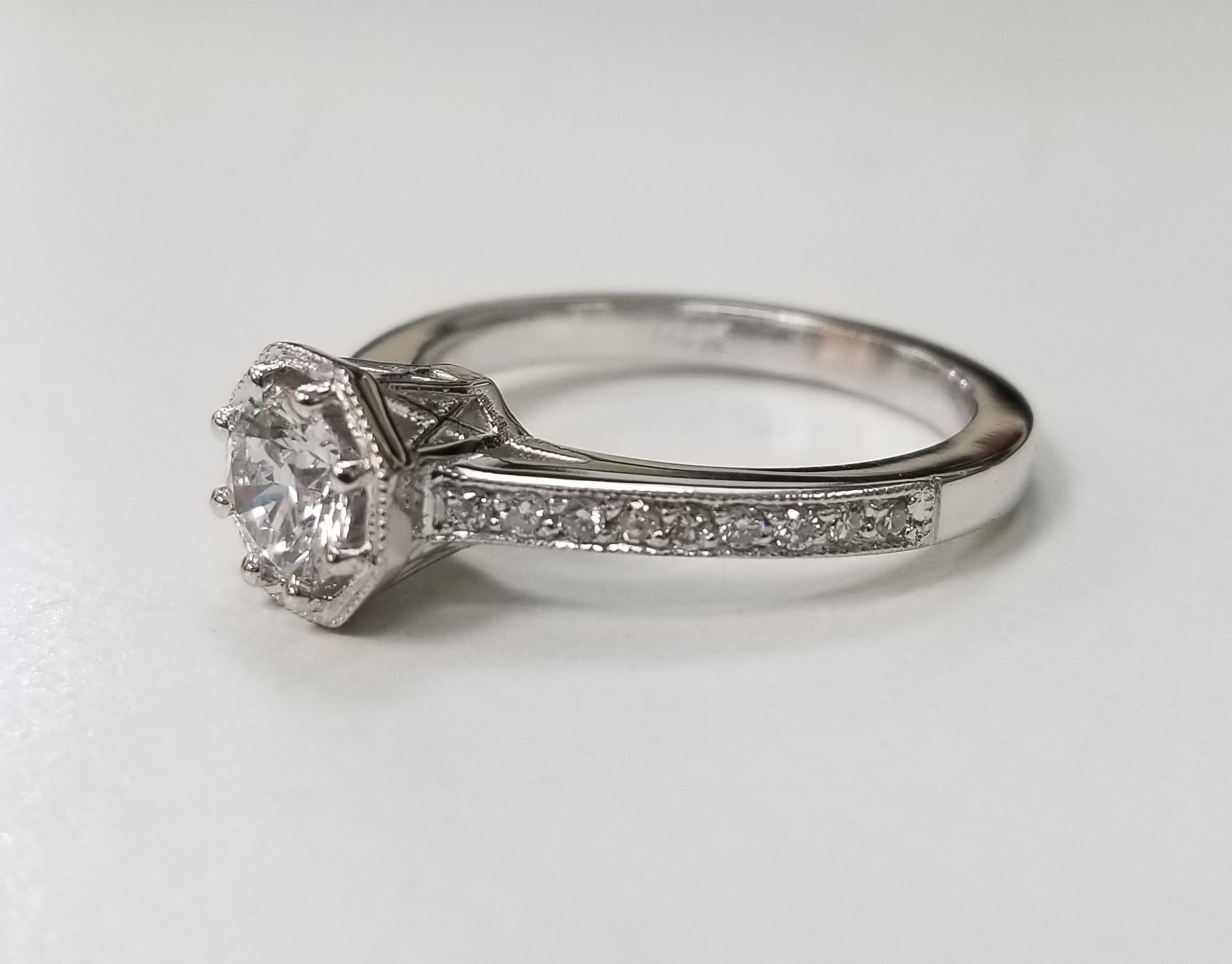 Art Deco Style GIA .57pts. H VS1  Diamond  Engraved Diamond Ring containing,
Specifications:
    main stone: Brilliant cut diamond
    additional: diamonds
    diamonds: round
    carat total weight: .15pts.
    color:H
    clarity: VS1 
    metal: