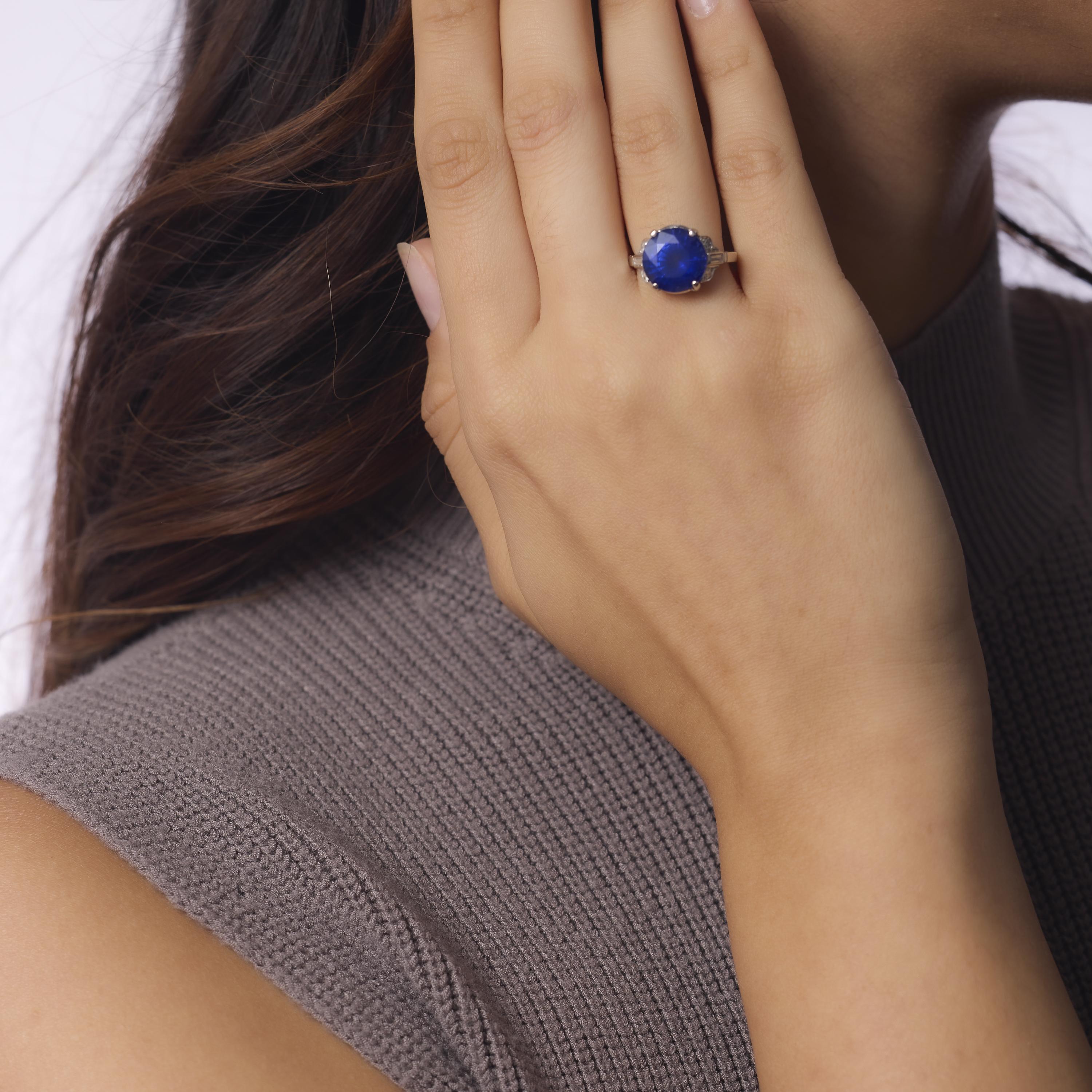 This Art Deco platinum ring showcases a stunning 7.45 carat GIA-certified heated Ceylon sapphire in a rare round brilliant cut, flanked by six single and baguette cut diamonds. Crafted in the 1930s, its bold geometry and elegant setting reflect the