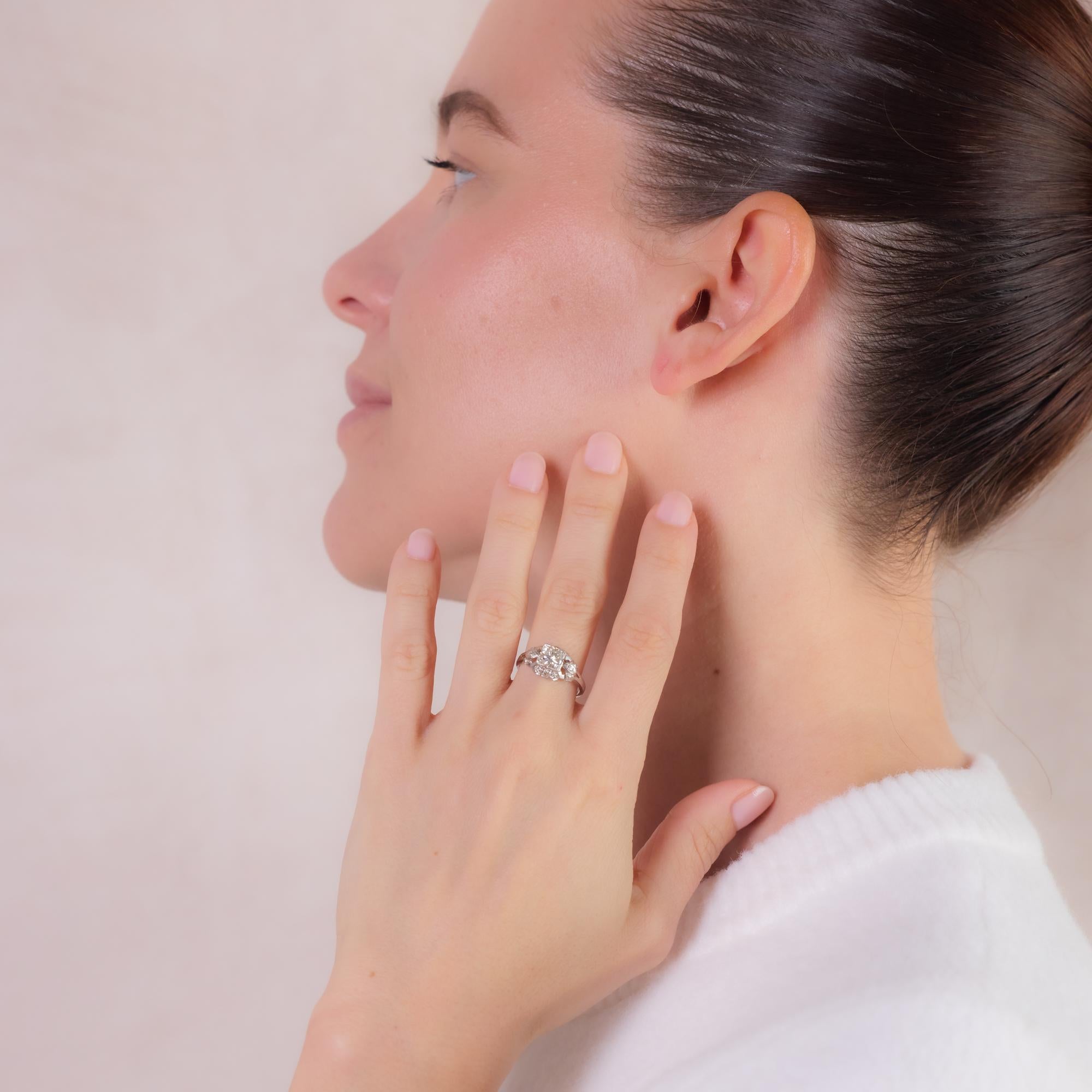 This elegant Art Deco platinum engagement ring features a GIA-certified 0.76-carat old European cut diamond, I color, VS2 clarity, accented by 12 single-cut diamonds totaling approximately 0.15 carats, H color, SI-I clarity. A timeless design with