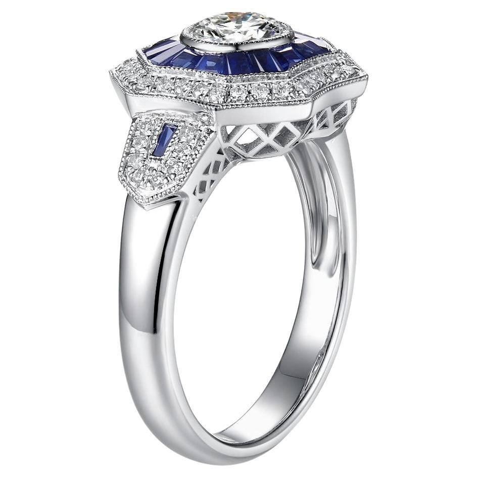 This ring features a 0.50 carat round brilliant cut diamond at the center (Color: E, Clarity: Internally Flawless, Cut: Very Good). Assented with 0.98 carat of natural sapphires halo set in platinum. This ring is brand new. It has been created to