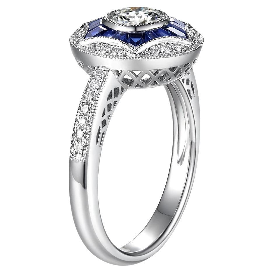 Dieser Ring verfügt über einen GIA-zertifizierten Diamanten in der Mitte Gewicht 0,50 Karat, G Farbe, VVS 2 Klarheit mit ausgezeichnetem Schliff. Der zentrale Diamant ist von einem 0,74 Karat schweren natürlichen Saphir umgeben. Die auf der