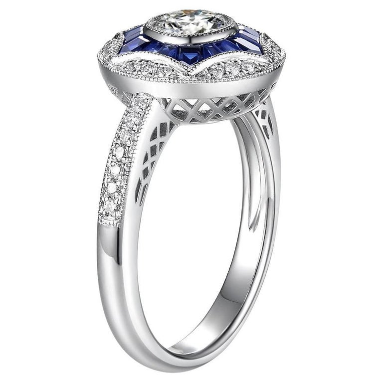 This ring features a GIA certified diamond at the center weight 0.50 carat, G color, VVS 2 clarity with excellent cutting. Center diamond is surrounded by 0.74 carat of natural sapphire. Diamonds set on the shoulder of the ring and diamond halo