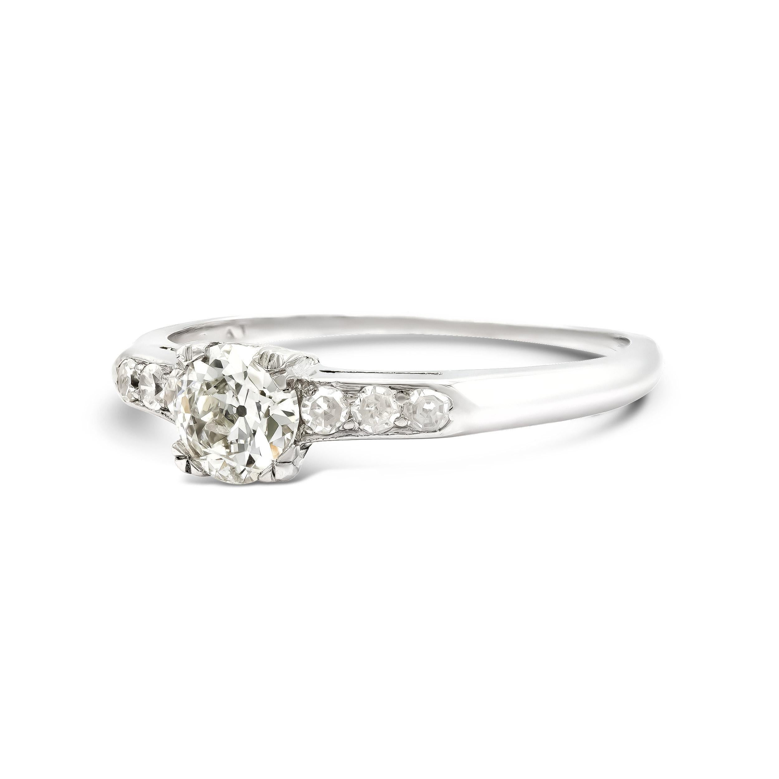 A quintessential art deco engagement ring style with so much to love. The center old Euro is as pretty as a picture, facing bright and light. We love the shouldering accent stones and the dainty platinum setting. This ring sits beautifully on the