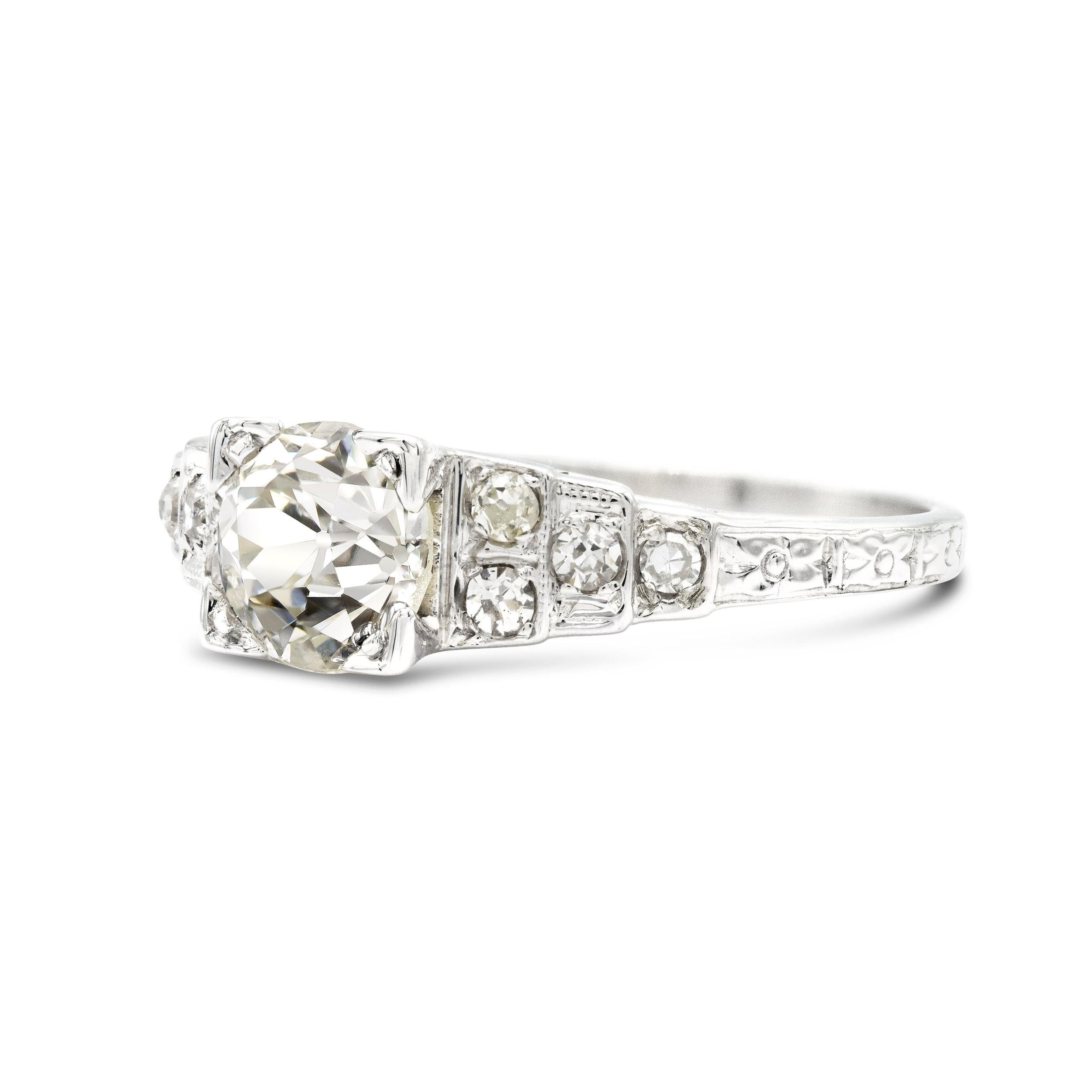 A ring that has all the distinguishing features of the era it comes from. A 0.87 carat old Euro in an illusion setting centers this sweet Art Deco engagement ring. We especially love the graduated shoulders studded with super bright single cut