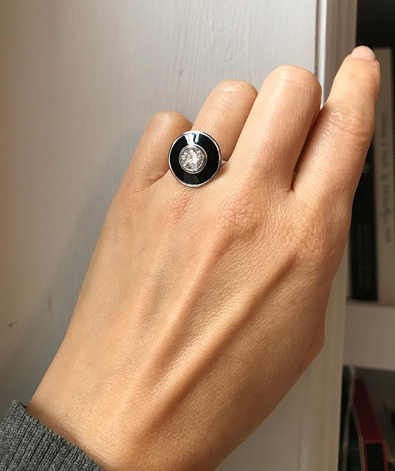 Rooted in clean, classic lines, this bold yet elegant ring reflects the individuality of the wearer. Using the classic black vitreous hot enamel surrounded by 18k white gold it transports us back to a time of sparkle and glitz. The hand-picked I SI2