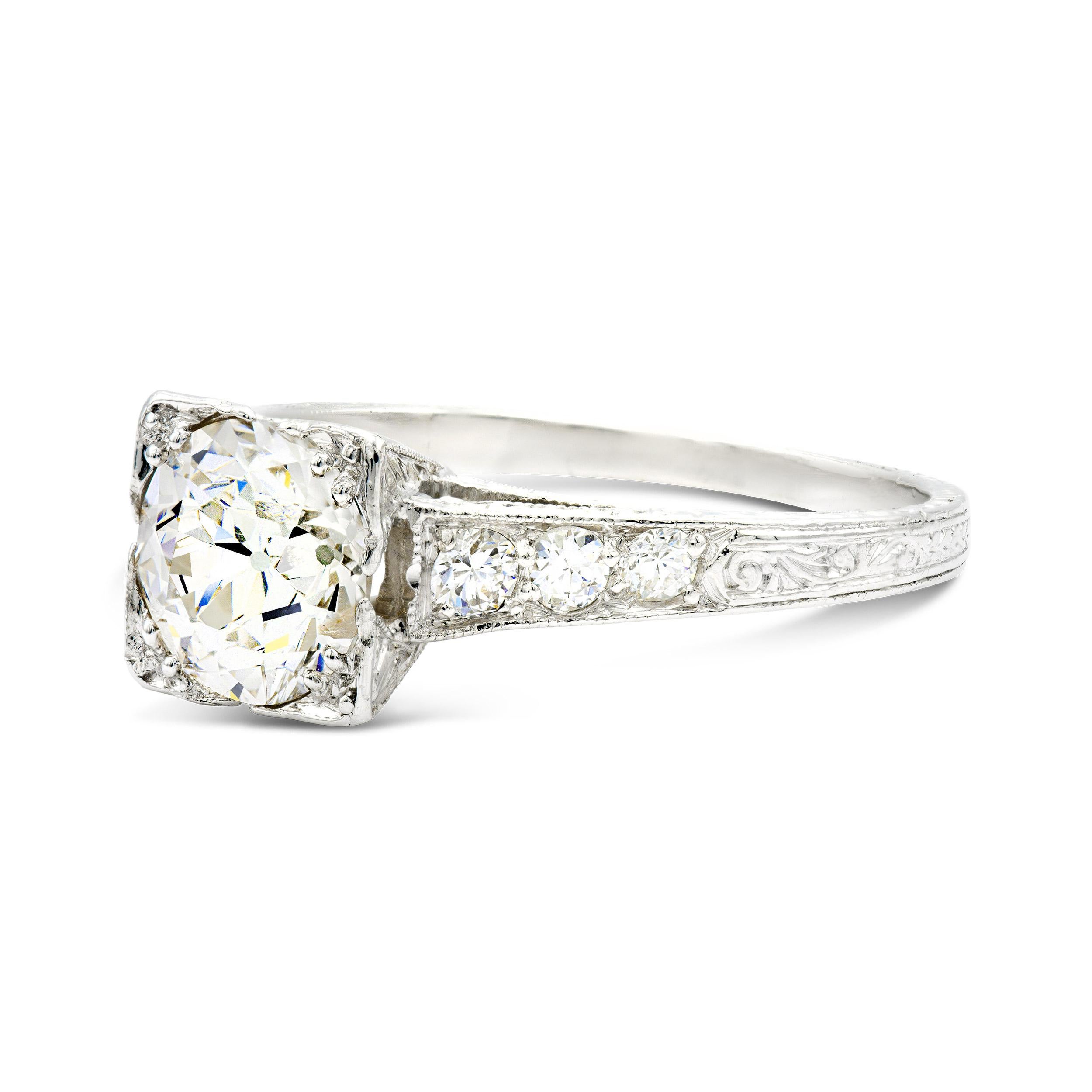 We love the intricate and extensive hand engraved details of this platinum deco engagement ring. Centering this jewel is a 1.29-carat old European cut diamond with a large culet and tons of sparkle. The artisanship of this piece and classic design