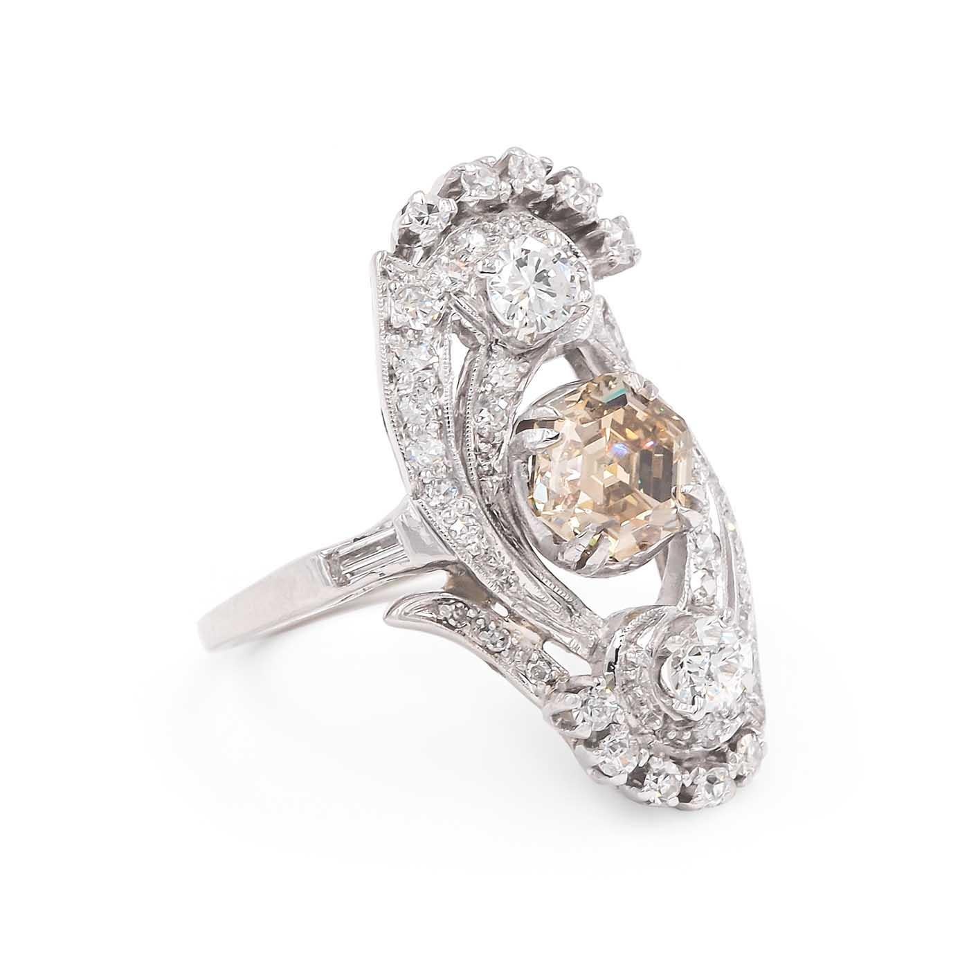 Art Deco Era 1.43 Carat Hexagonal Step Cut Diamond 'Dinner' Ring composed of platinum. With a 1.43 carat hexagonal Step Cut Diamond, GIA certified to be Natural Fancy Brownish Yellow color/VS1 clarity. Also set with an additional 41 diamonds, a