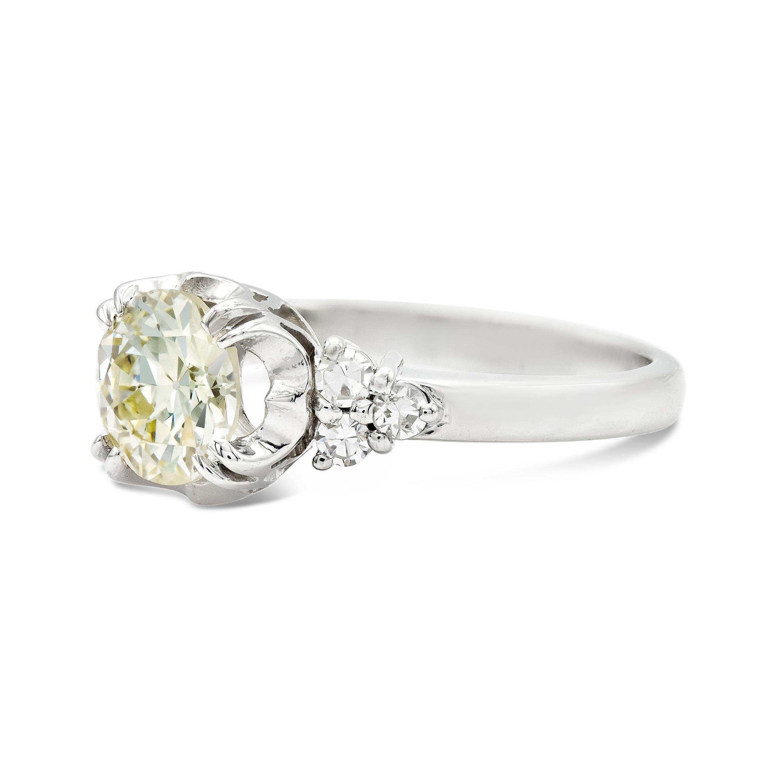 This deco era engagement ring is an absolute delight. A 1.44 carat old European cut diamond centers with its amazing facet pattern, it truly dances. We love the double claw prongs and buttercup style setting. A trio of single cut diamonds shoulder