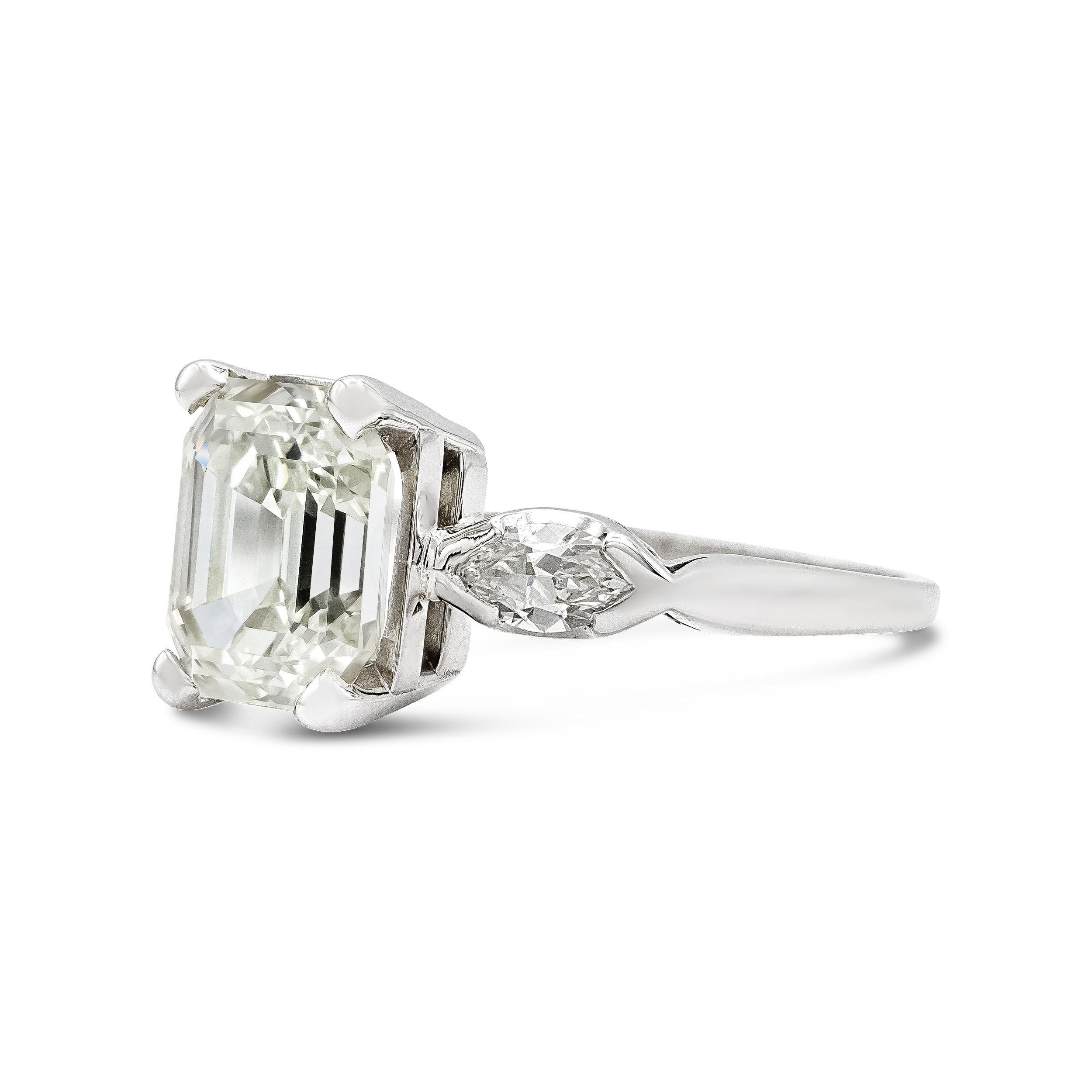 This quintessential Deco engagement ring is a true cut above. At her center is a nearly flawless 2.75 ct. cut-cornered emerald cut diamond with a small table, and well-suited proportions. It's superior cut is brilliantly illuminated by distinctive