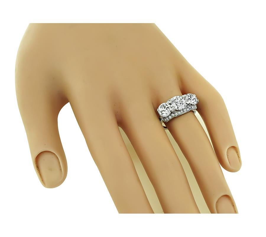 This is a stunning platinum anniversary ring from the Art Deco era. The ring is set with 3 sparkling GIA certified old European cut diamonds that weigh 1.70ct, 1.18ct and 1.15ct. The color of the diamonds is L with VS2 clarity, J with VS2 clarity
