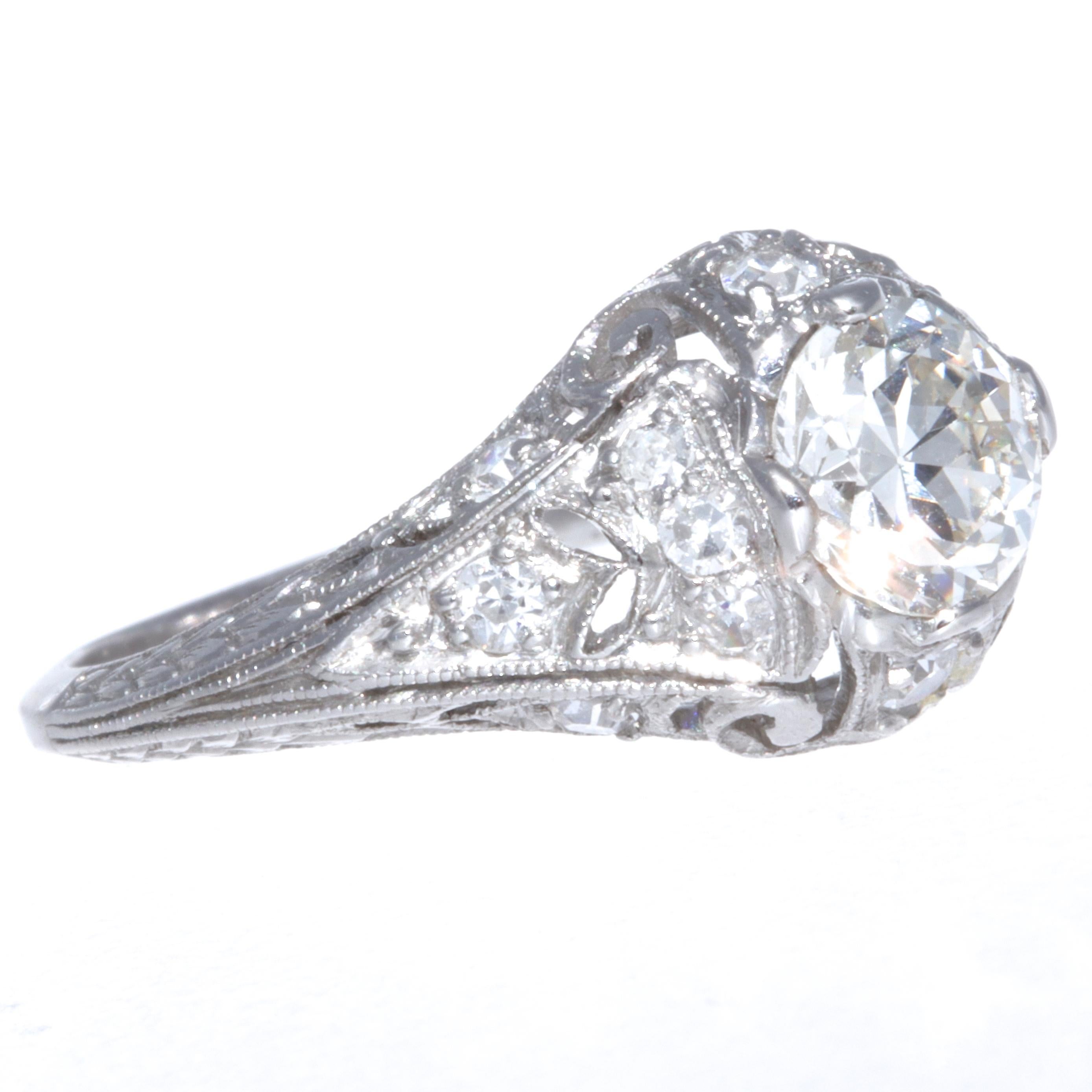 All stylistic elements of a true Art Deco period are included in this stunning Art Deco diamond platinum filigree engagement ring. So dreamy and jazzy, this ring features a GIA certified Old European Cut 0.74 carat K color VS2 clarity. Fifteen