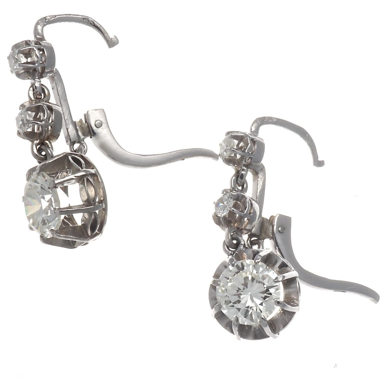 Gorgeous Art Deco diamond 18k white gold drop earrings, that will make you want to hold your head high.  Featuring 2 GIA certified old European cut diamonds. One 1.19 carat, K color VS1 and one 1.35 carat, K color SI2. The 4 smaller stones are rose