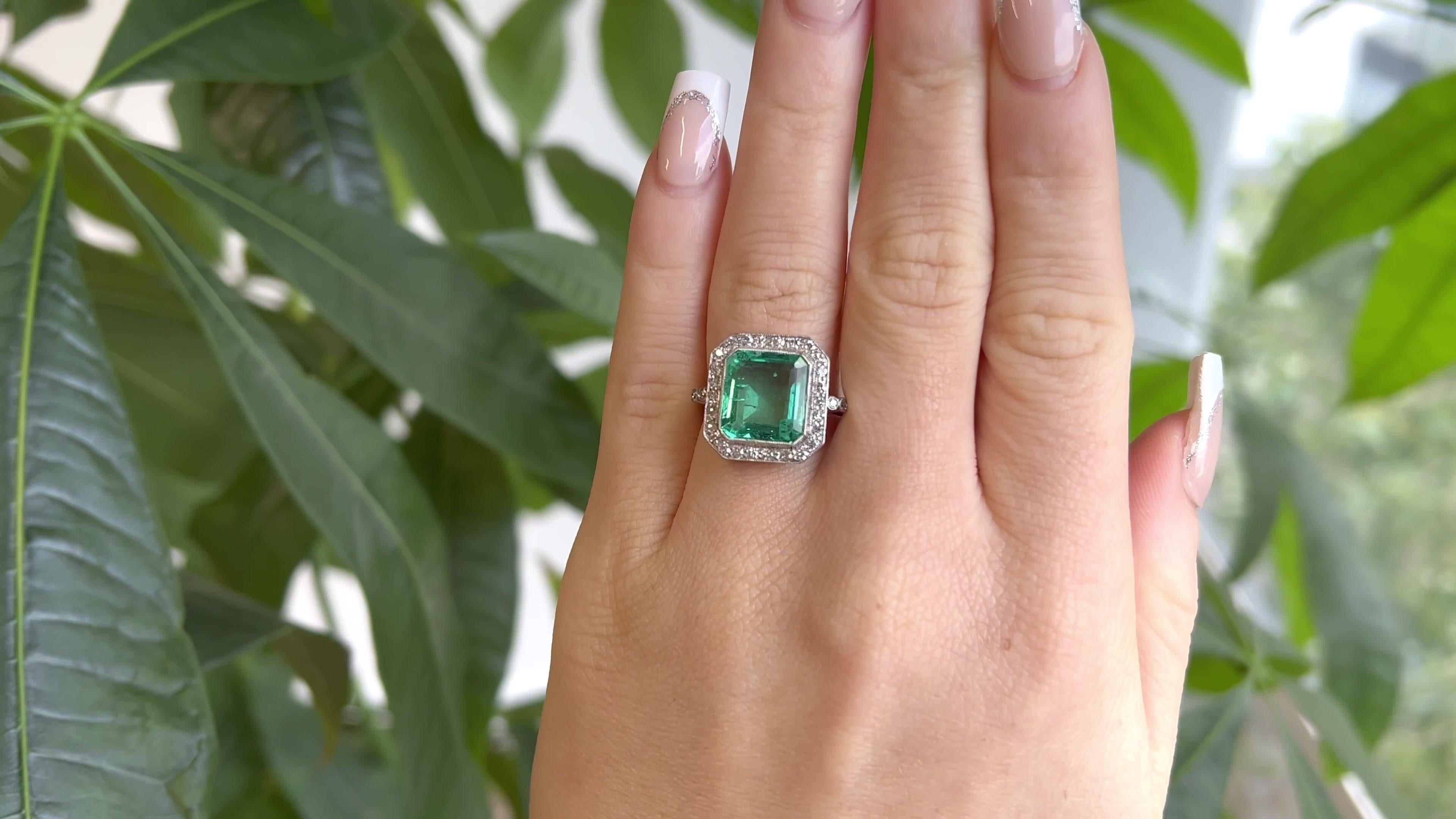 One Art Deco GIA Colombian 5.00 Carats No Oil  Emerald Diamond Platinum Ring. Featuring one GIA certified octagonal step cut emerald of approximately 5.00 carats, accompanied with certificate #2221379973 stating the emerald is of Colombian origin