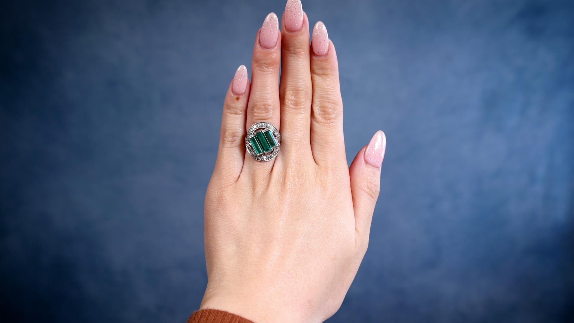 One Art Deco GIA Colombian No Oil Emerald and Diamond Platinum Ring. Featuring three rectangular step cut emeralds with a total weight of approximately 2.50 carats. Accompanied by GIA #5234160636 stating one of the emeralds is of Colombian origin