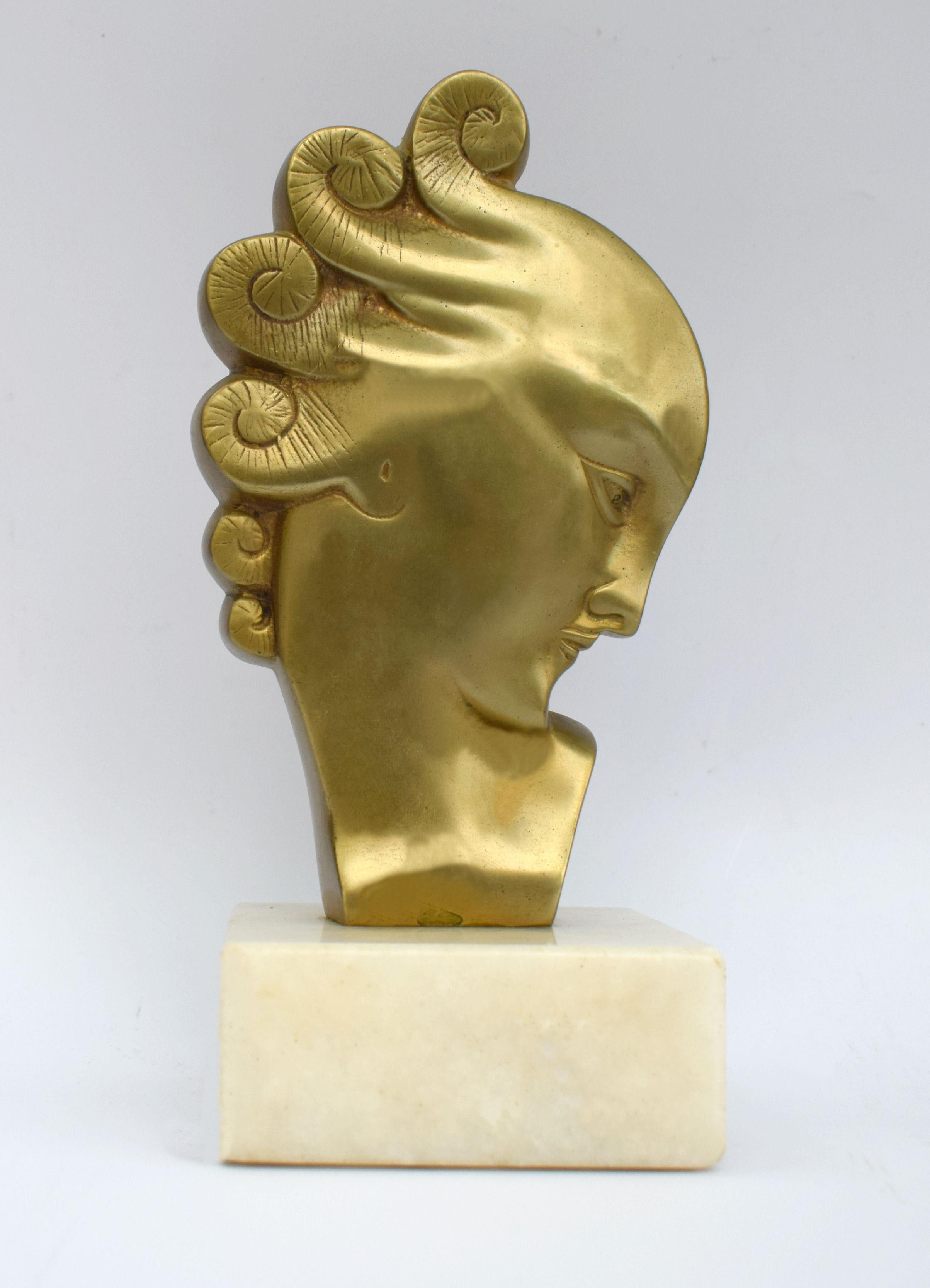 Magnificent Art Deco female profile head in gilded bronze sitting on a white marble base. Dating to the 1930s and originating from France. Although not signed it's very much in the style of Haguenauer's work. Lovely condition free from damage or any