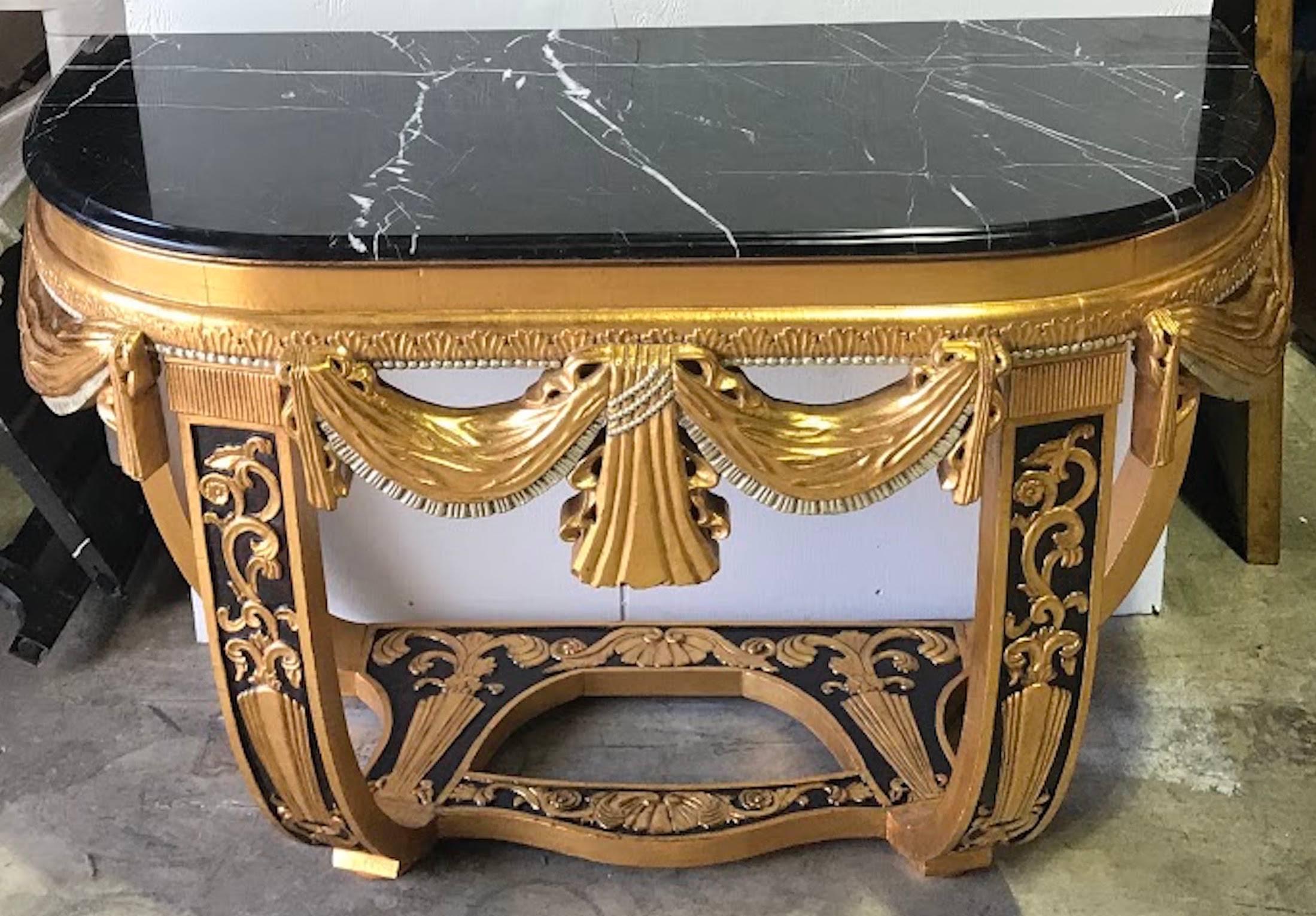 Art Deco Gilt and Polychromed Marble-Top Console Table in the Style of Sue et Mare, France, 1920s–30s

A dramatic and richly detailed Art Deco giltwood and polychromed console table with a black marble top, inspired by the luxurious interiors of
