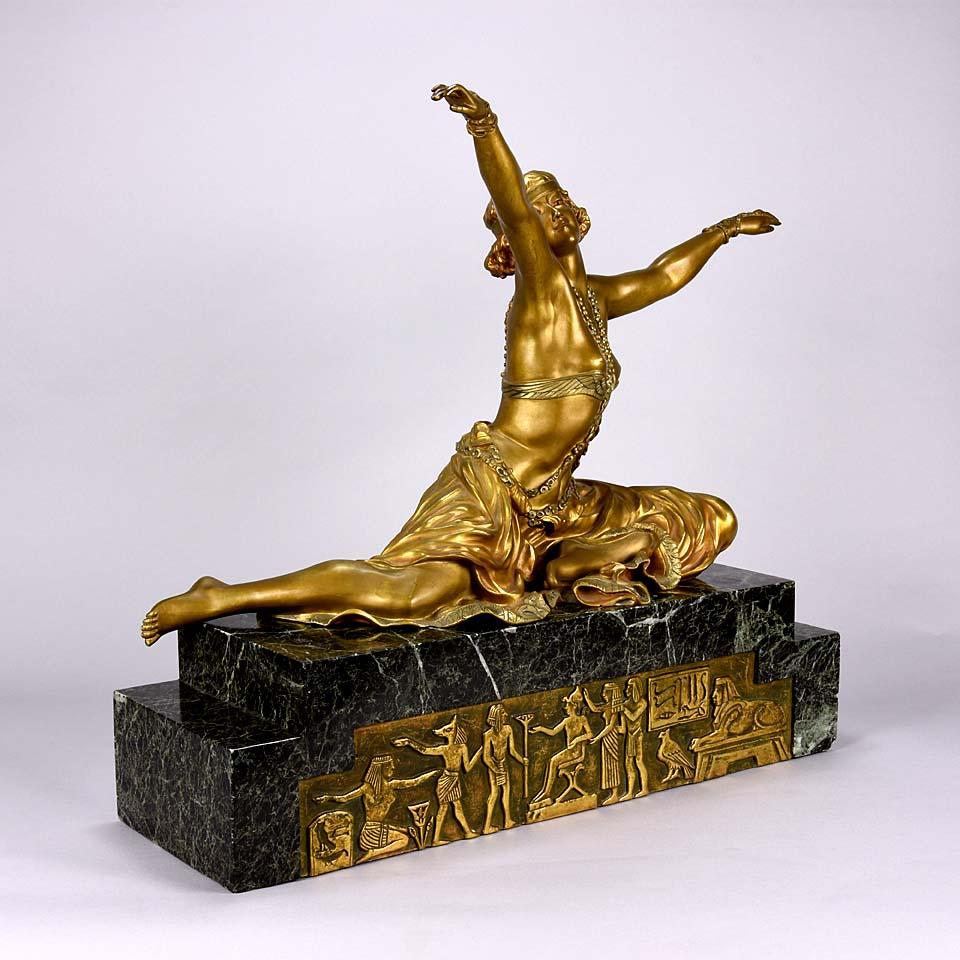 Magnificent early 20th century French Art Deco gilt and enamel bronze figure of a seated wearing an exotic and revealing costume, with very fine color and excellent detail, signed Cl.J.R.Colinet.



Claire Jeanne Roberte Colinet (1880–1950) was