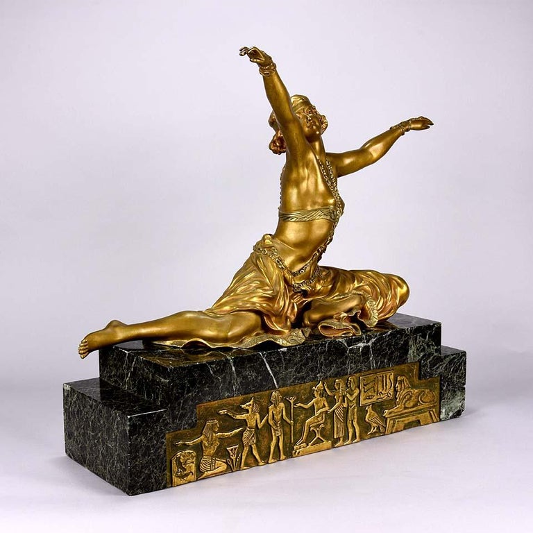 Magnificent early 20th century French Art Deco gilt and enamel bronze figure of a seated wearing an exotic and revealing costume, with very fine color and excellent detail, signed Cl.J.R.Colinet.



Claire Jeanne Roberte Colinet (1880–1950) was