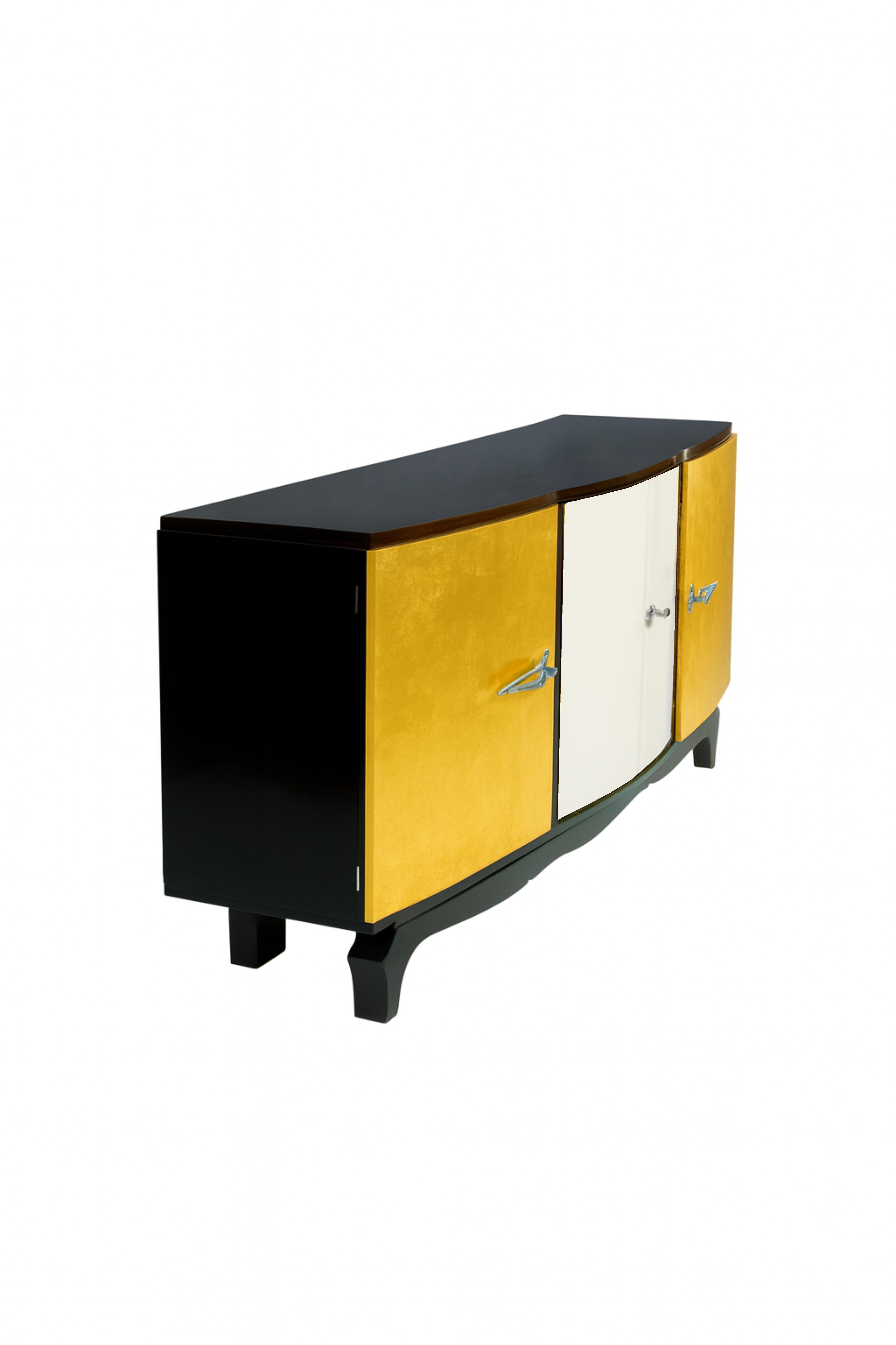 This stunning Art Deco gilted sideboard credenza, crafted in the 1930s, embodies the elegance and sophistication of the era. Blending American influence with French flair, the piece features chromed handles and hardware that gleam against its rich