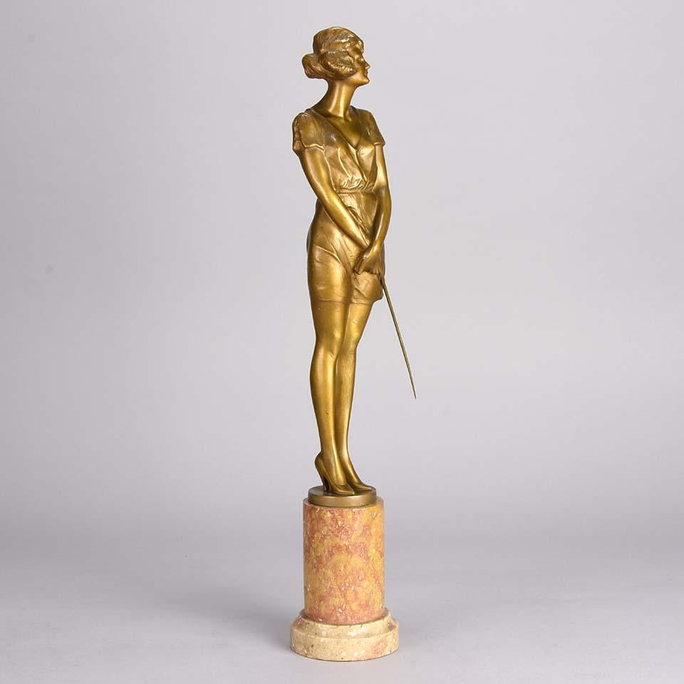 A fabulous Art Deco gilt bronze figure of a beautiful woman wearing a loose fitted figure hugging dress and high heels holding a riding whip, with excellent color and very fine hand finished detail, signed Zach.

Bruno Zach (German, 1891–1935) -