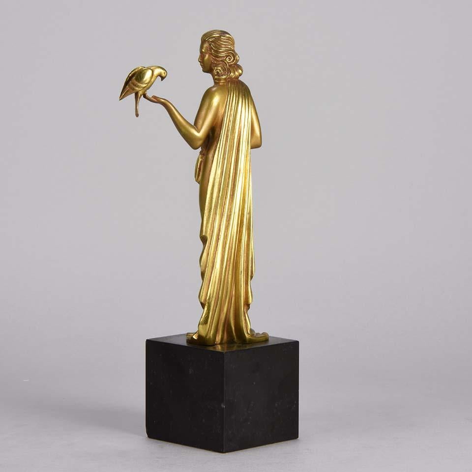 French Art Deco Gilt Bronze figure 'Femme avec Oiseau' by Pierre Laurel For Sale