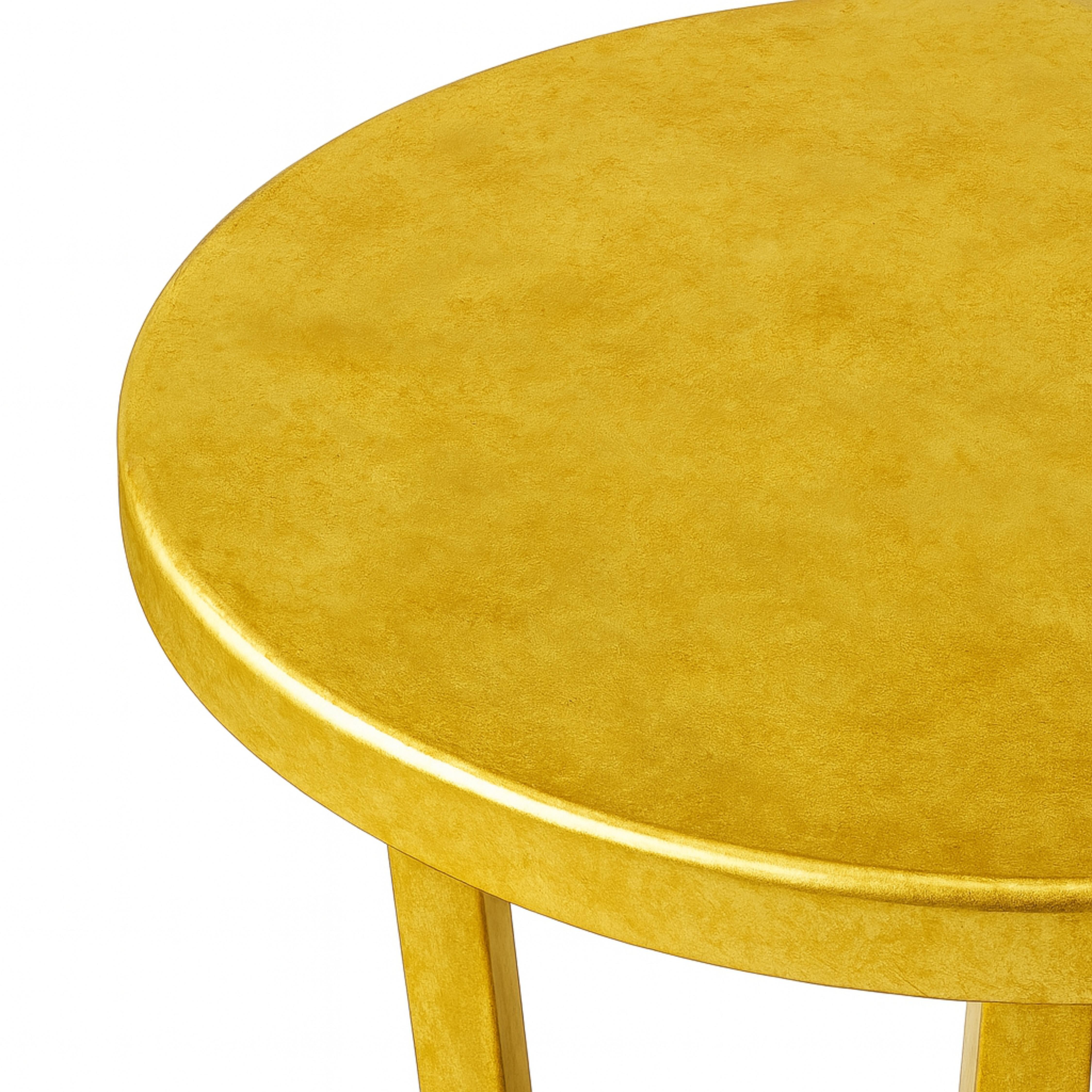 A study in elegance and proportion, this table showcases a sculptural silhouette finished in a e artisanal gilt finish. The finishing highlights its graceful lines and subtle curvature, creating a surface that catches and reflects light with