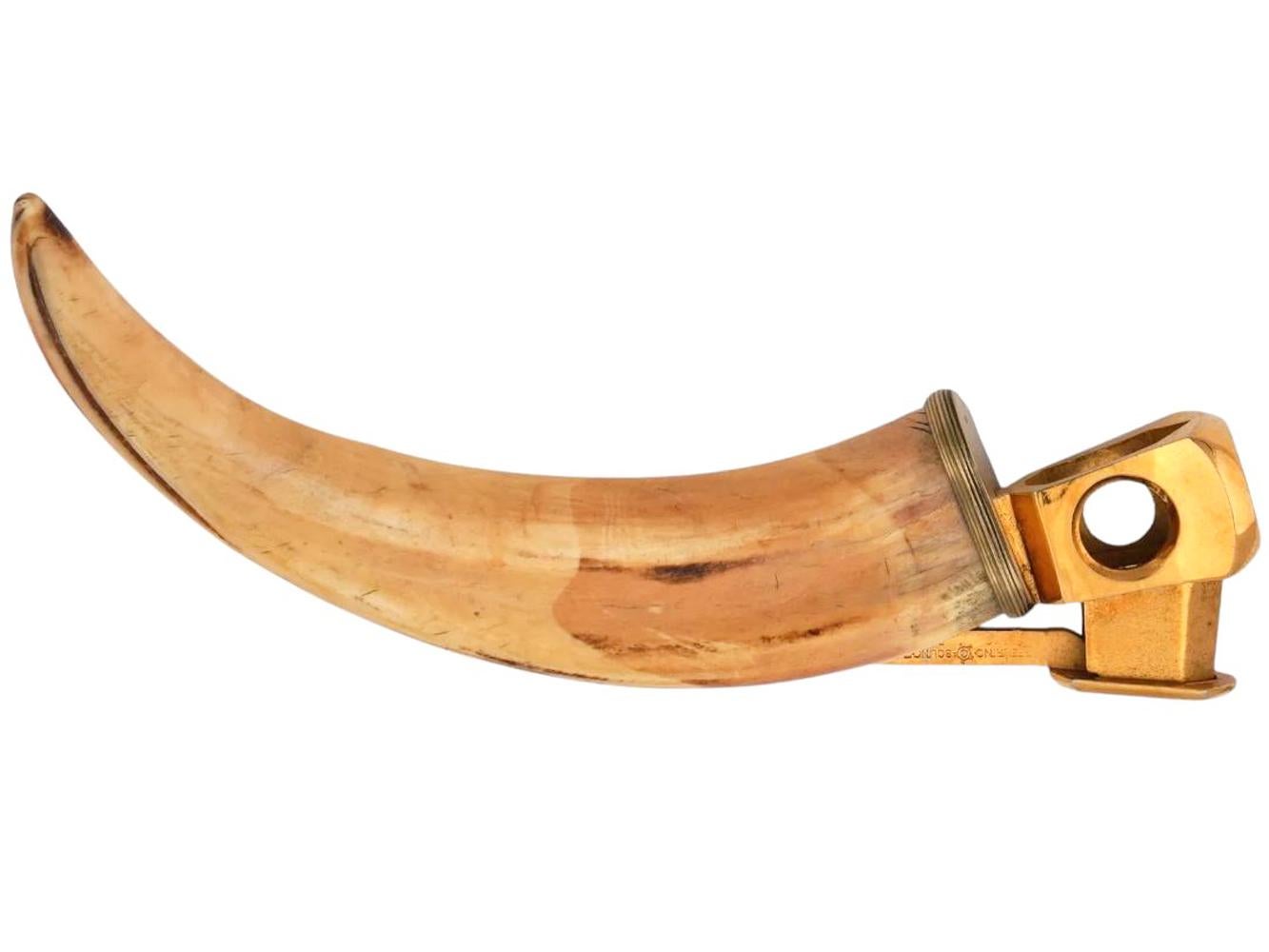 Art Deco gilt sterling silver mounted boars tusk cigar cutter with a thumb-push cutter mounted to the tusk and finished with a finely reeded collar.
Markes: Sterling / Solingen / Germany