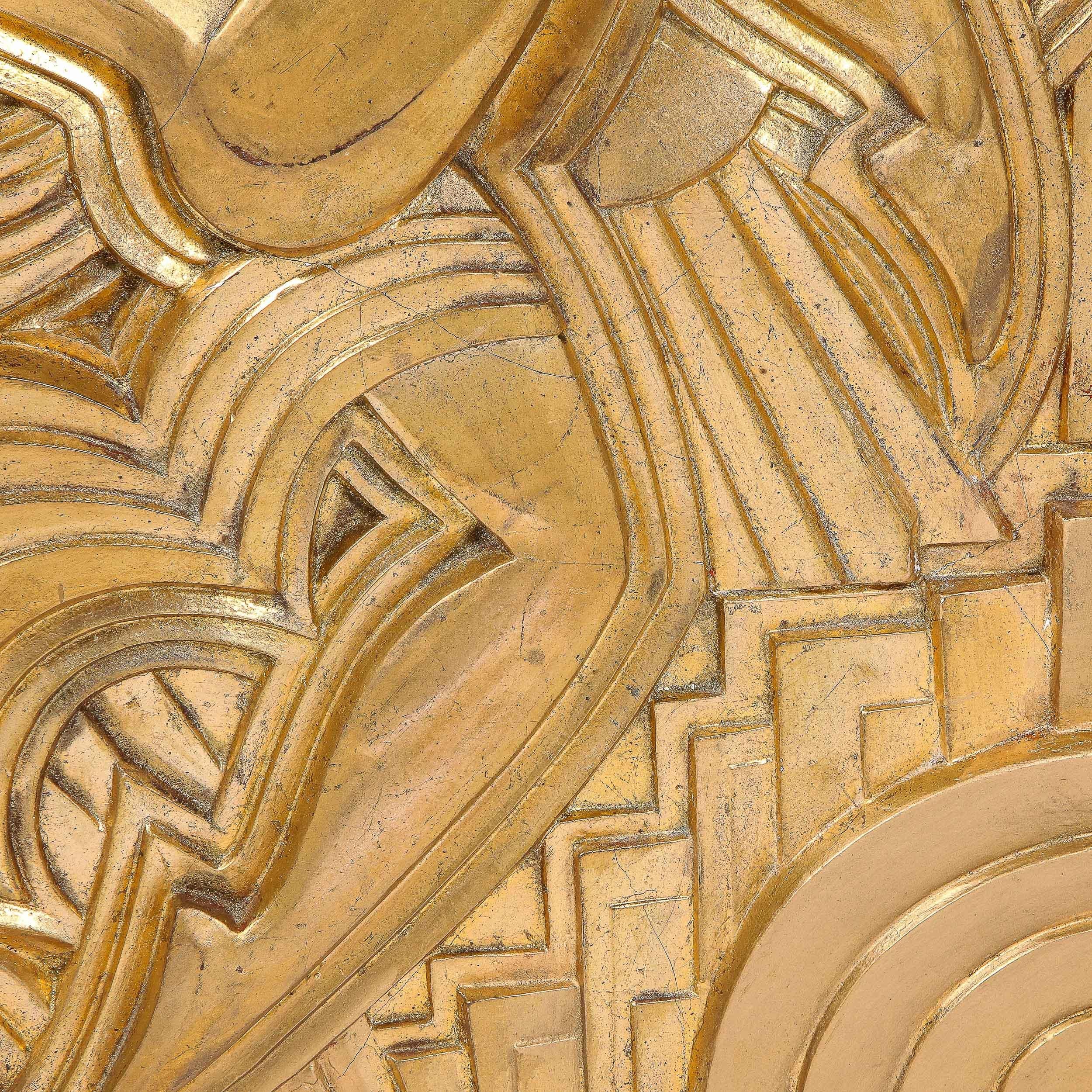 This stunning Art Deco giltwood plaque was realized by the esteemed artist Maurice 