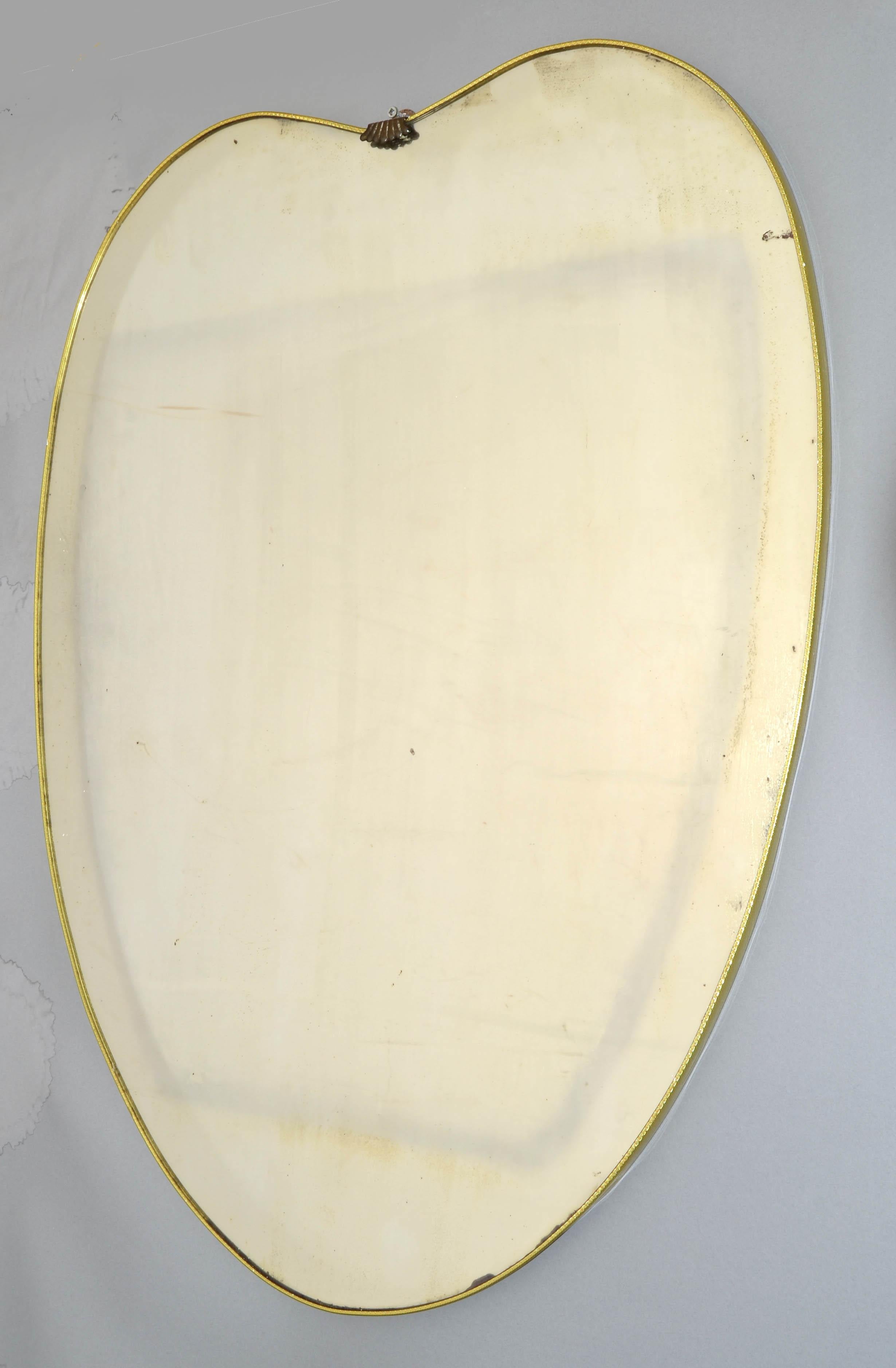 Art Deco 1950s whimsical Brass Heart Mirror in the Style of Gio Ponti and similar to Paolo Buffa.
All Original handcrafted Brass Band with hardwood backing for secure hanging.
In good vintage condition with some specks and foxing to the Mirror