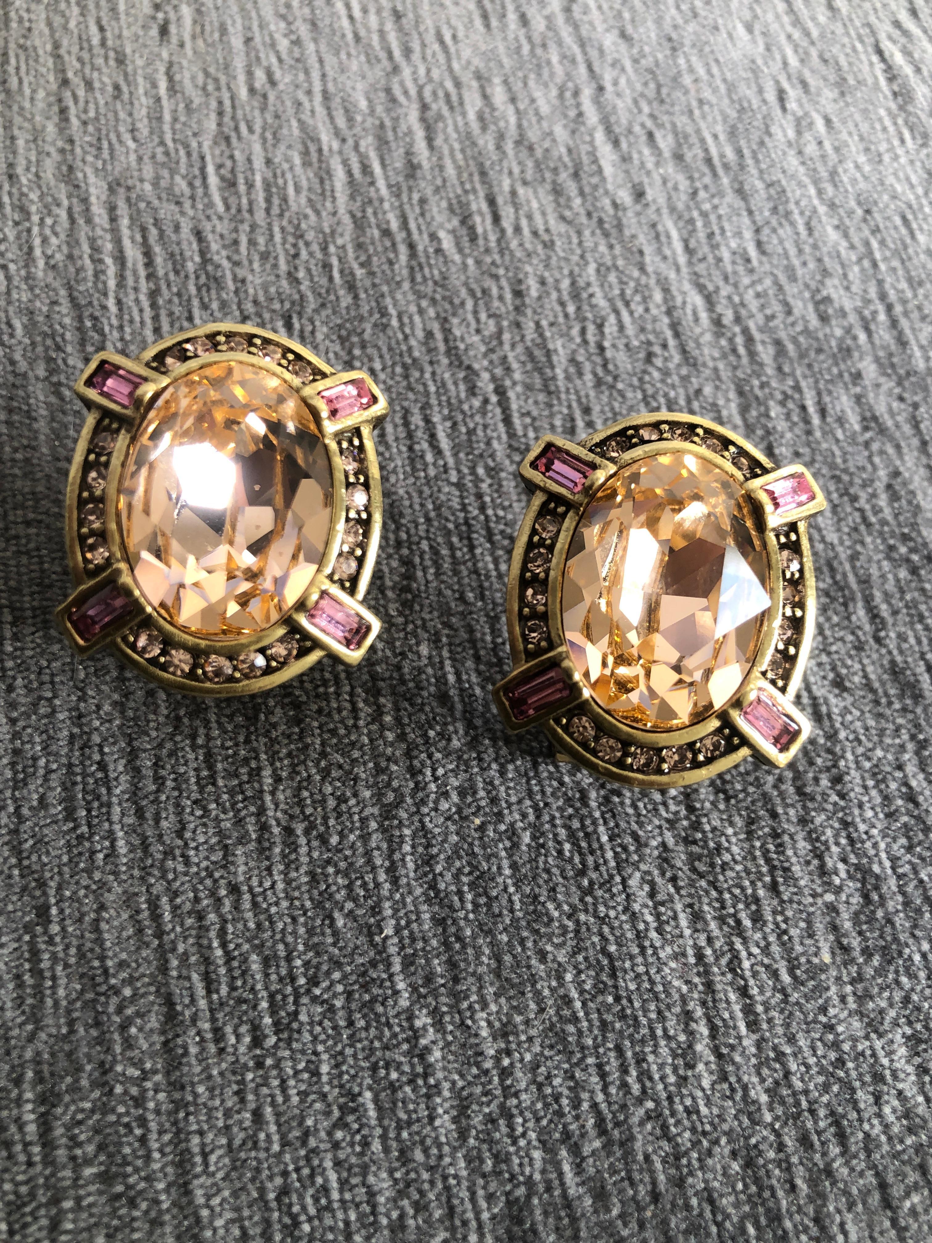 Just a gorgeous pair of glamorous designed by uber chic Heid Daus. A large blush color crystal oval surrounded by 4 pink crystal baguettes. On antique gold color metal. So Art Deco. this pair and 9 others listed today, all came from a very chic and