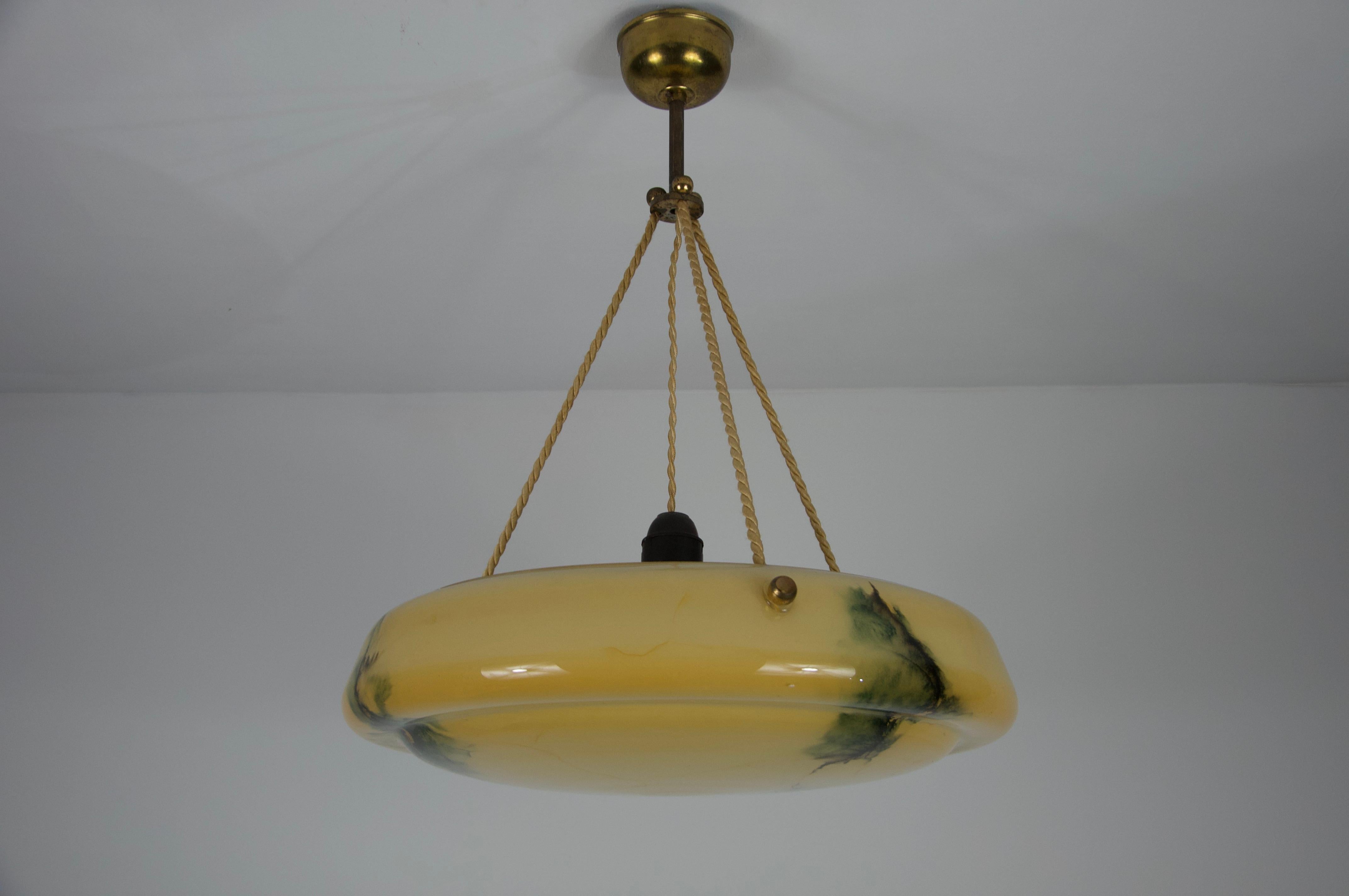 Beautiful glass pendant lamp from the 1930s, made in Germany. The soft, diffused light passing through the glass creates a warm and inviting atmosphere, making it a perfect centerpiece for any room. Its timeless design and high-quality craftsmanship