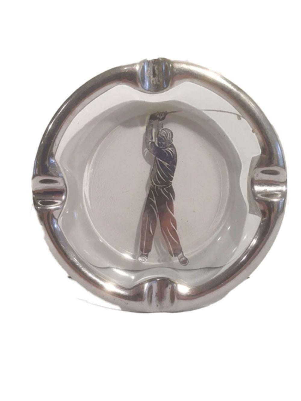 Vintage glass ashtray with applied sterling edge and a central image of a golfer swinging a club. The heavy glass with 4 divots for cigarettes and large enough to accommodate a cigar. Probably made by Rockwell Silver Co.