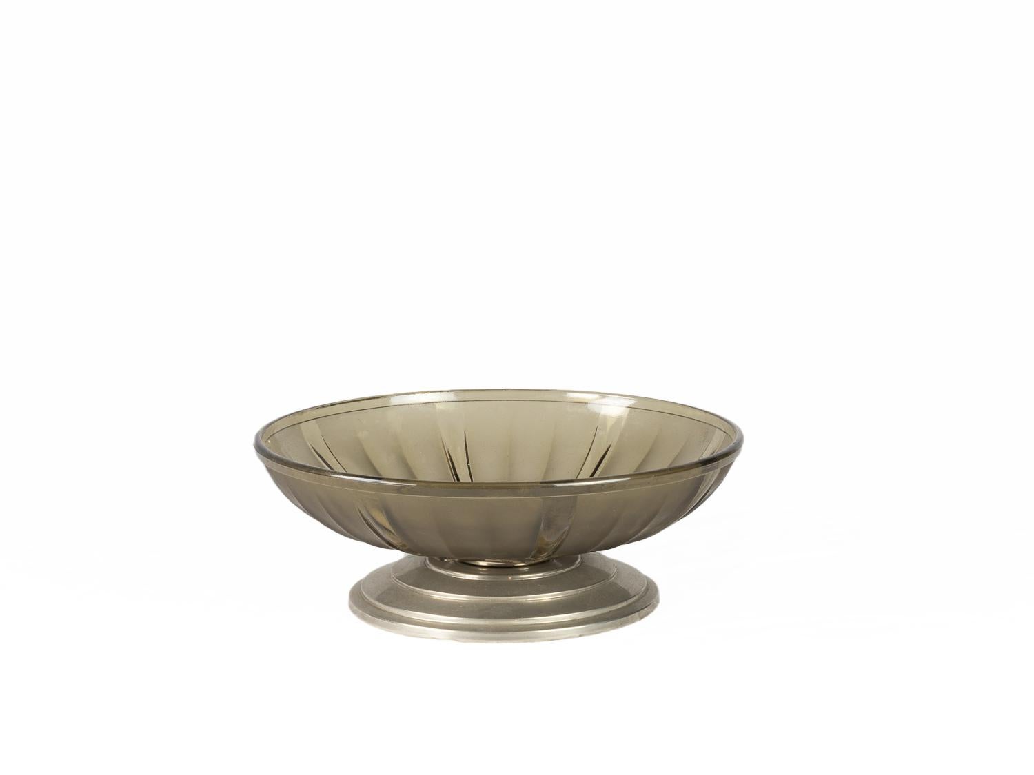 A Greyish glass centerpiece in smoked glass with metal base with pedestal