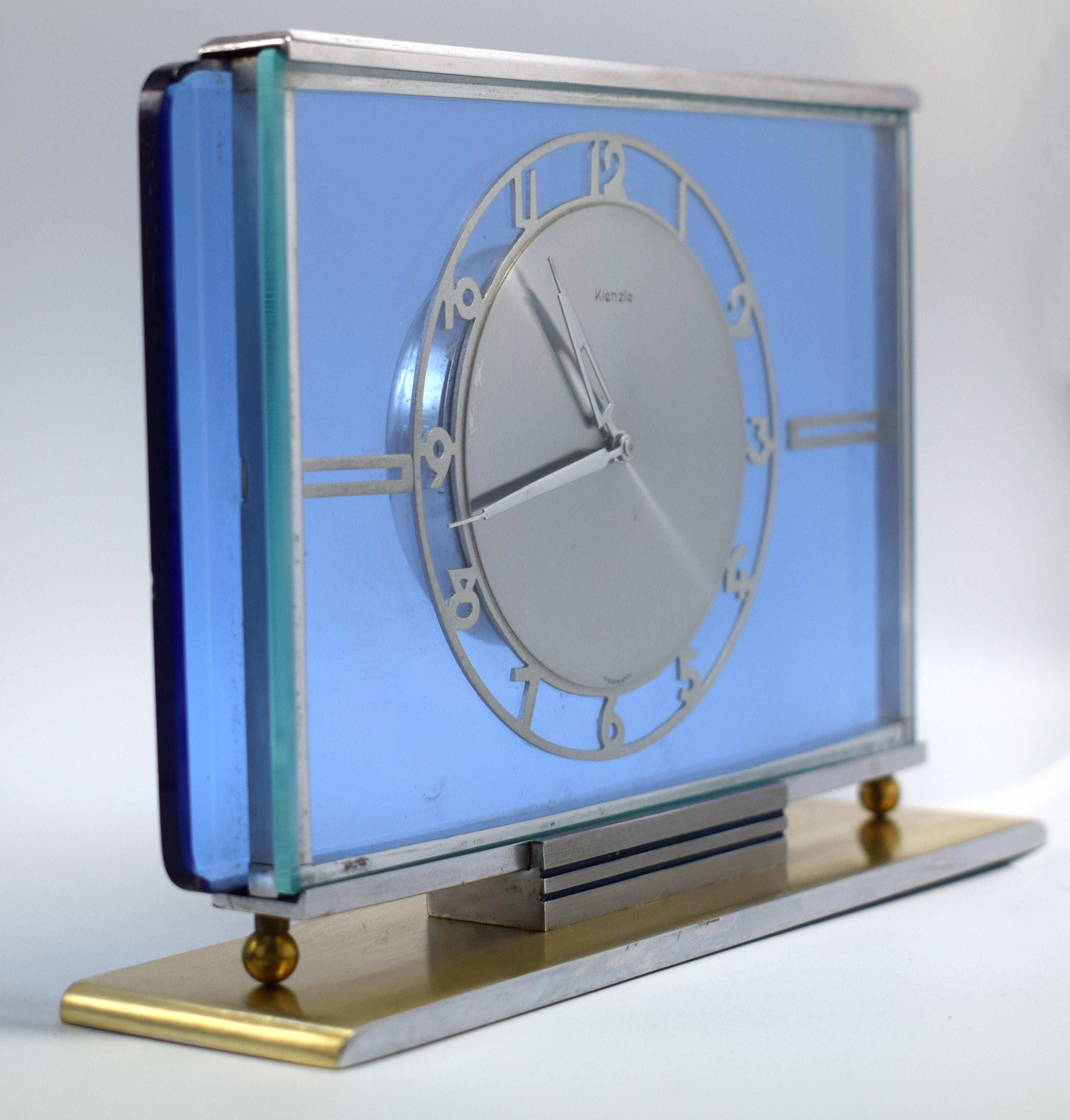 A beautiful and blue glass and silvered dial 8 day mantel clock manufactured by Kienzle, a fine example of the Art Deco style. Very attractive time piece. We've had this clock fully serviced and cleaned and so comes to you in full working order.